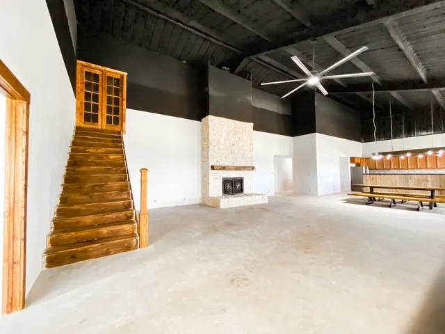 staircase to unfinished attic, 2600 sq ft of floor space in the main living room, with stone wood burning fireplace