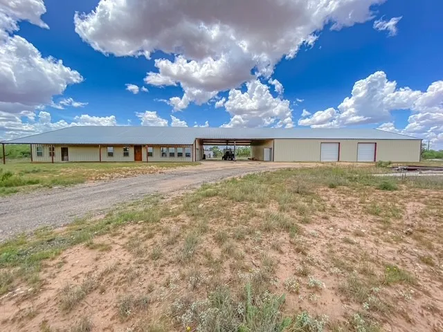 Front photo of the 12,000 sq ft structure, including 4800 sq ft Barndo, 2400sq ft Breezeway, and 4800 sq ft workshop. Car Port will fit 6 vehicles under it.