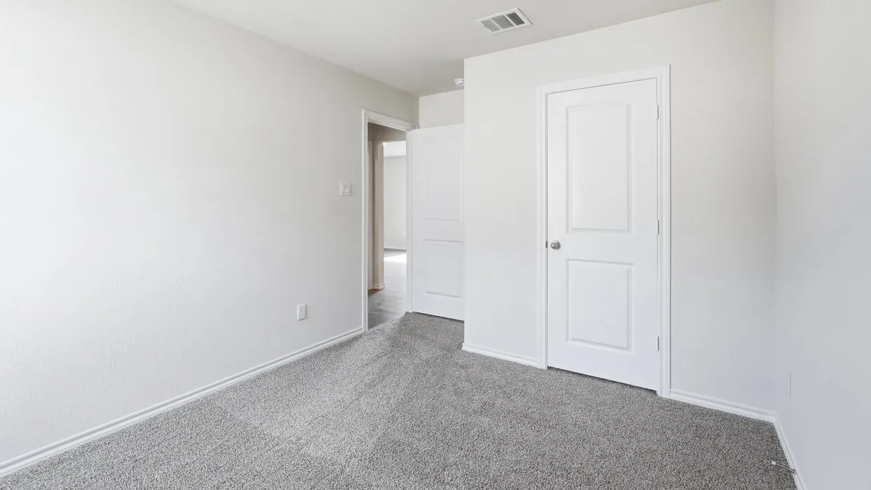 Neutral color palette featuring light gray carpeting and white painted walls