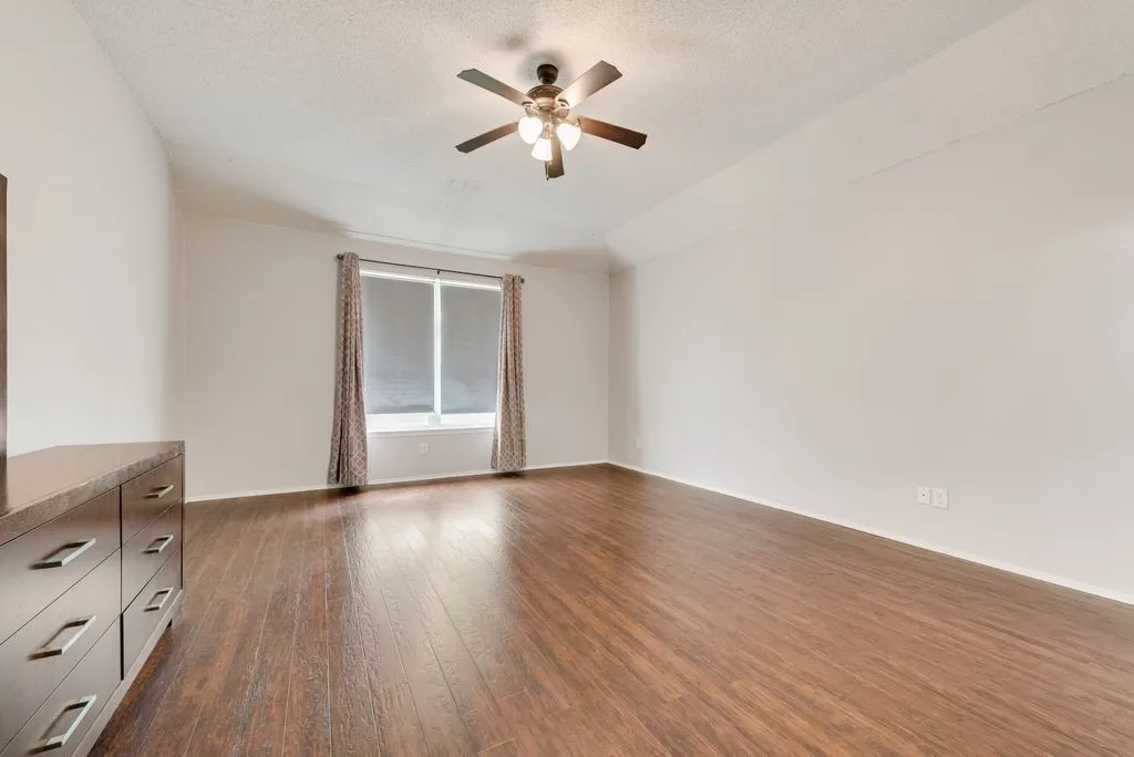 Huge master bedroom with window that looks out the back yard.
