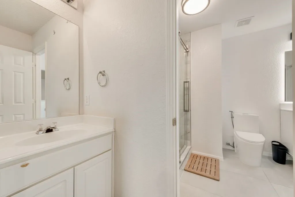 Full bath upstairs. Sink in the foreground is actually in the bedroom.