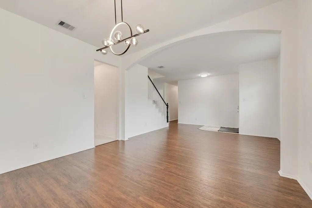 View of stairs and entry to kitchen from the formal dining area.
