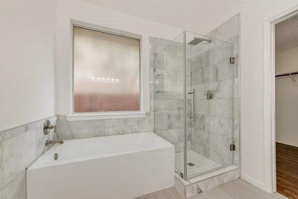 Separate tub and shower in primary bathroom.