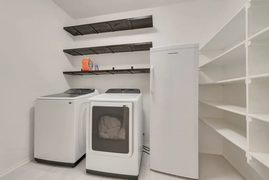 Combination laundry and pantry area.  Lots of great shelving. Washer and dryer stay with the house.