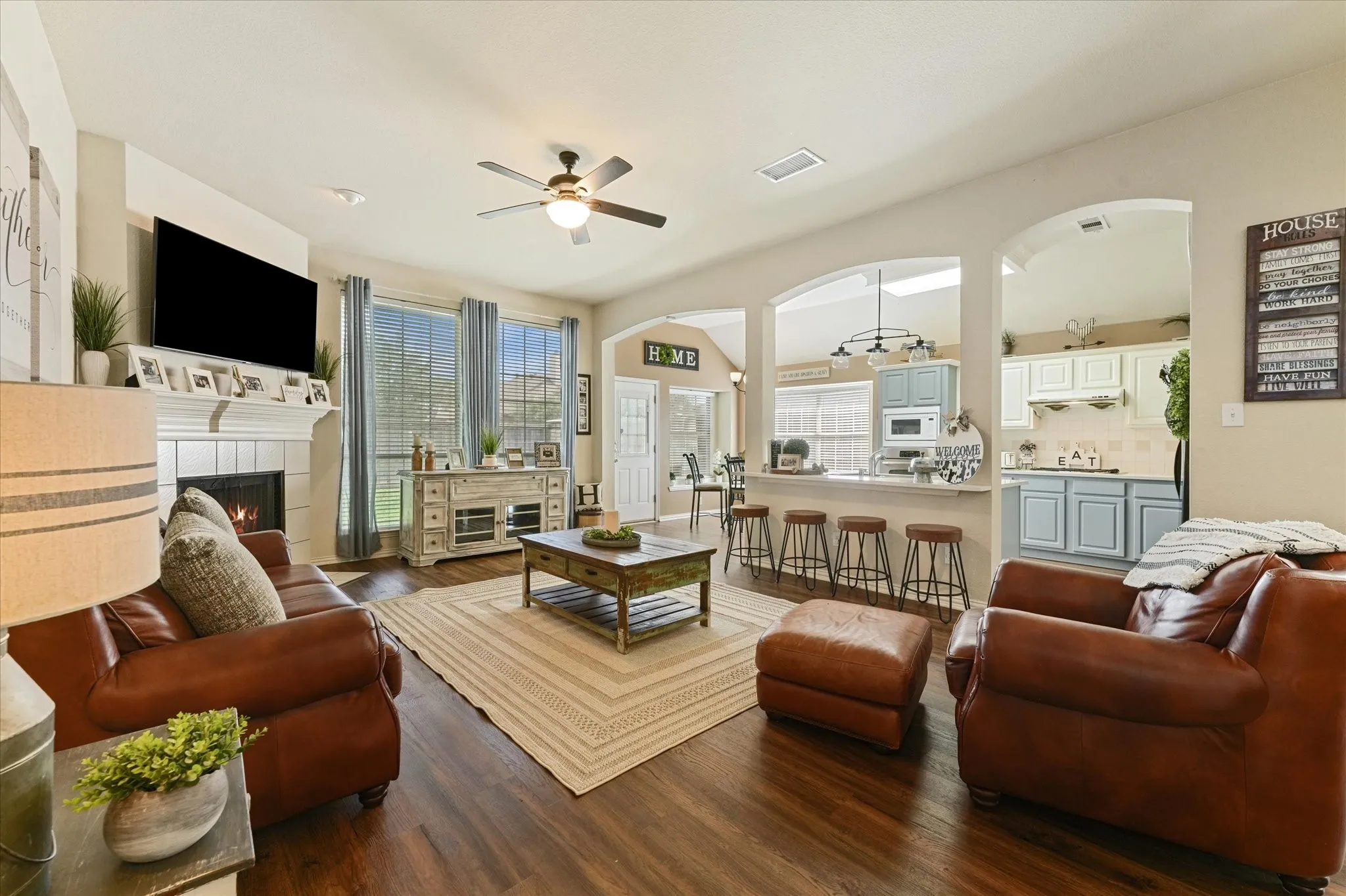 Spacious living room with a gas-start fireplace, abundant natural light, and an open-concept layout that connects seamlessly to the kitchen and breakfast area. Perfect for entertaining or everyday living.