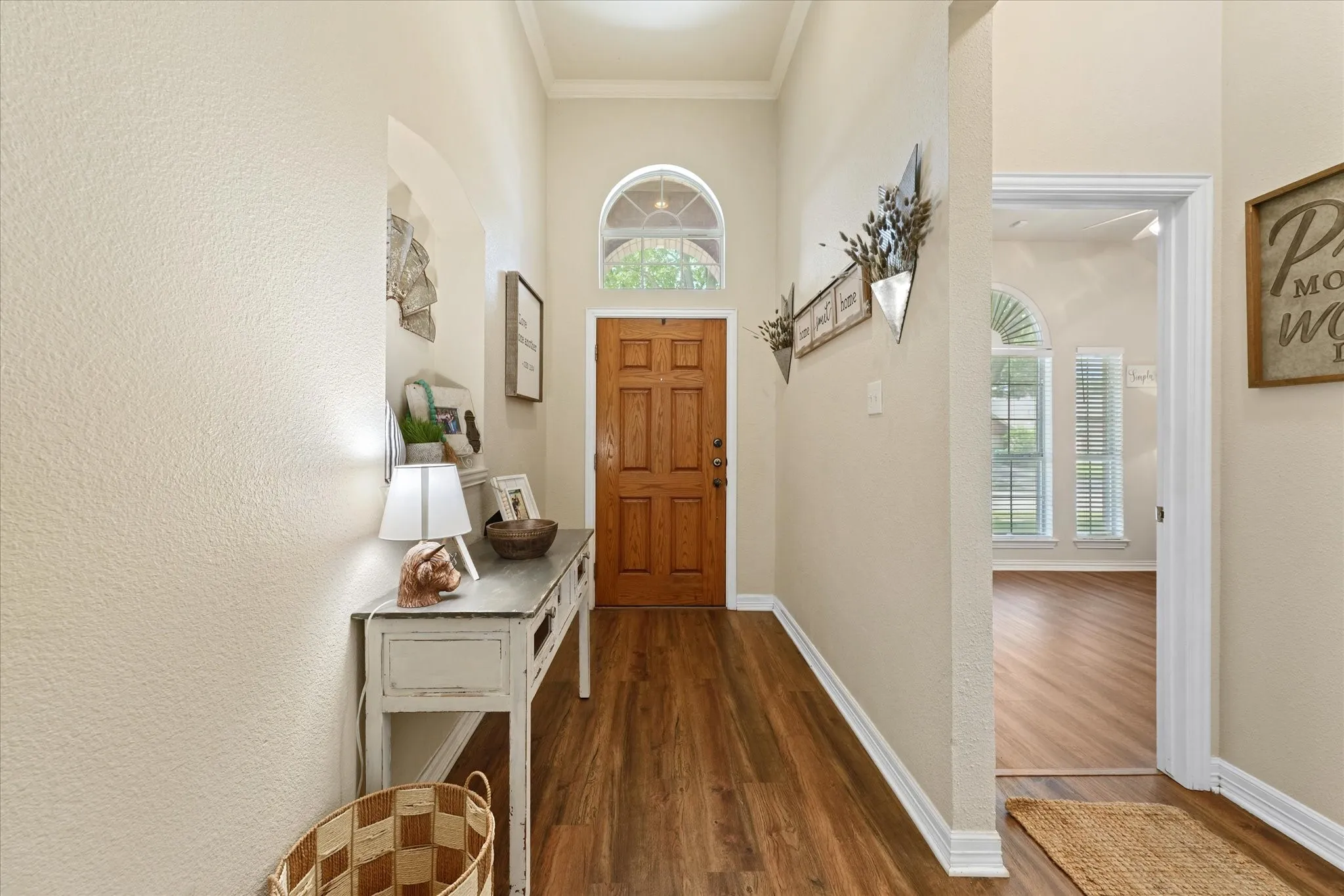 Step inside to soaring ceilings, abundant natural light, and durable luxury vinyl plank flooring that extends throughout the home. The spacious entry creates an open feel and sets the tone for the well-cared-for interior.