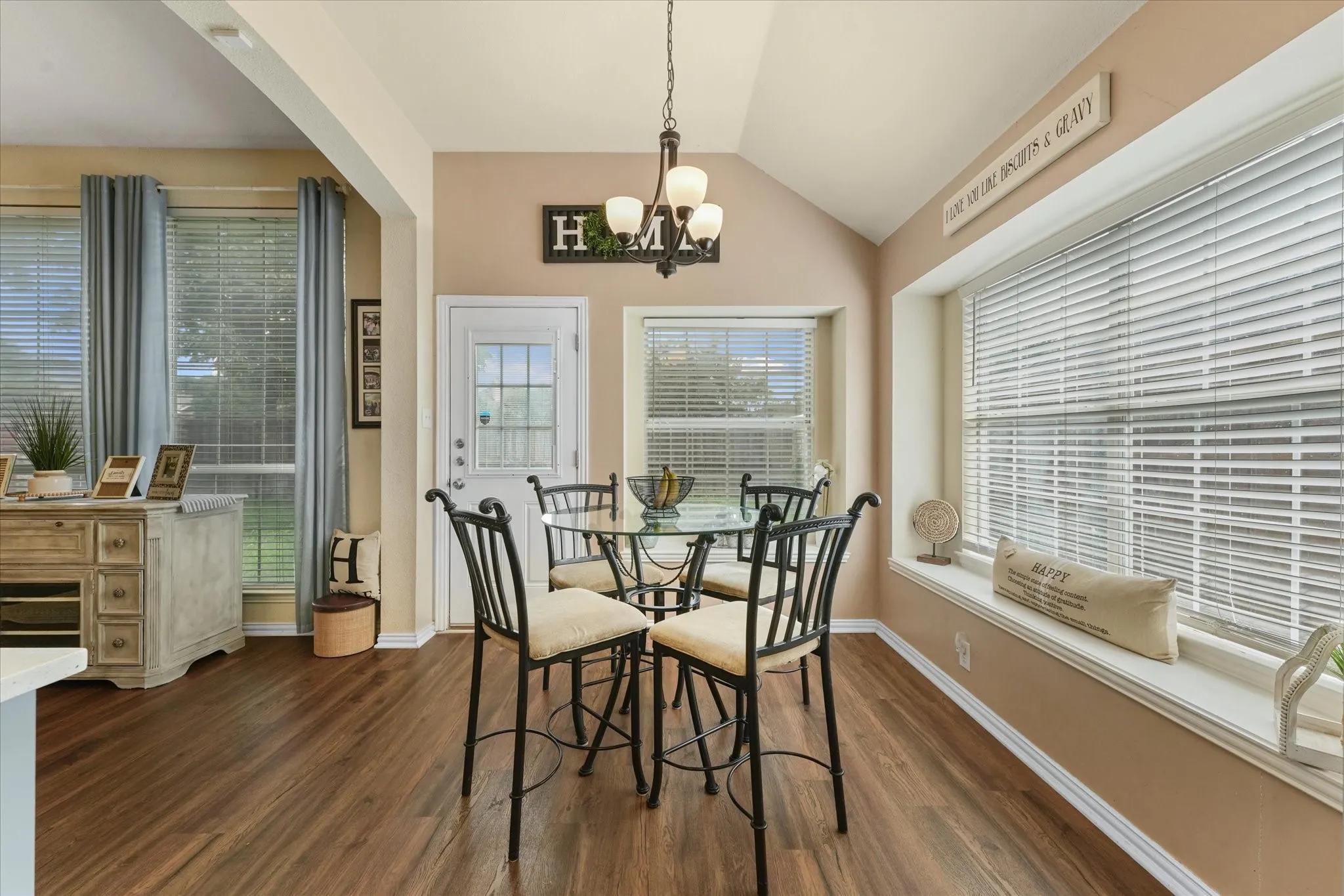 Sunny breakfast area with vaulted ceilings, large windows, and backyard views. A perfect spot for casual meals, morning coffee, or catching up at the end of the day.