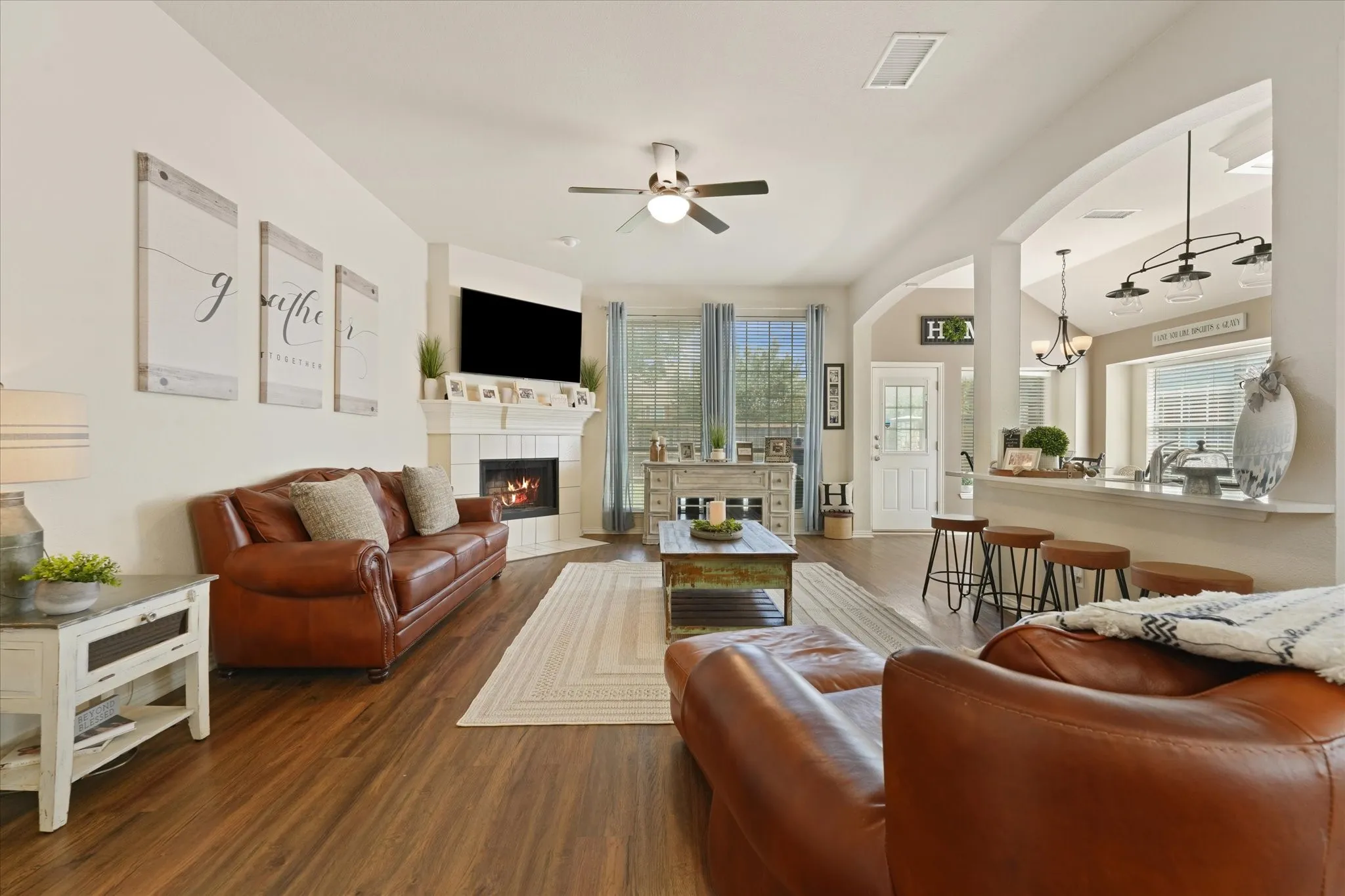 The heart of the home features updated flooring, large windows overlooking the backyard, and easy flow between the living room, kitchen, and dining spaces. The open layout creates a comfortable gathering place for family and guests.
