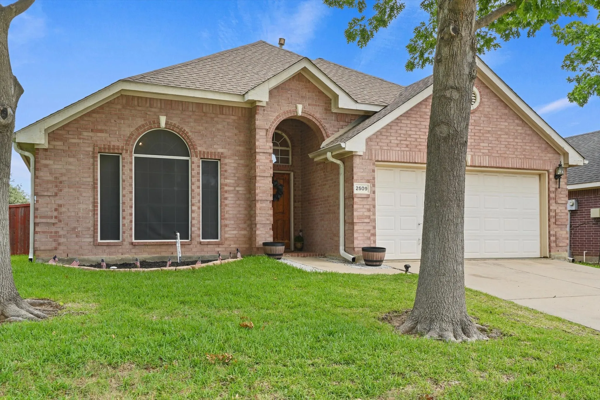 Established shade trees provide comfort and character while enhancing the home's curb appeal. The landscaped front yard offers a welcoming setting in one of Denton's convenient south-side neighborhoods.