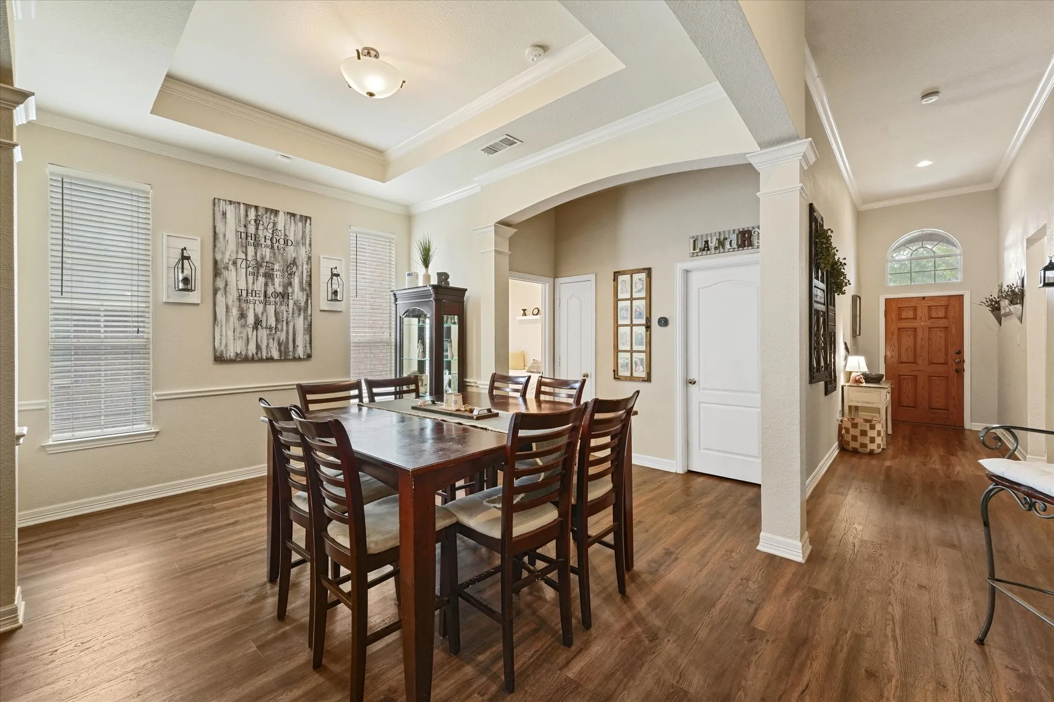 Located between the entry and main living areas, the formal dining room offers an open feel while maintaining distinct spaces for entertaining. Architectural details add character without sacrificing functionality.