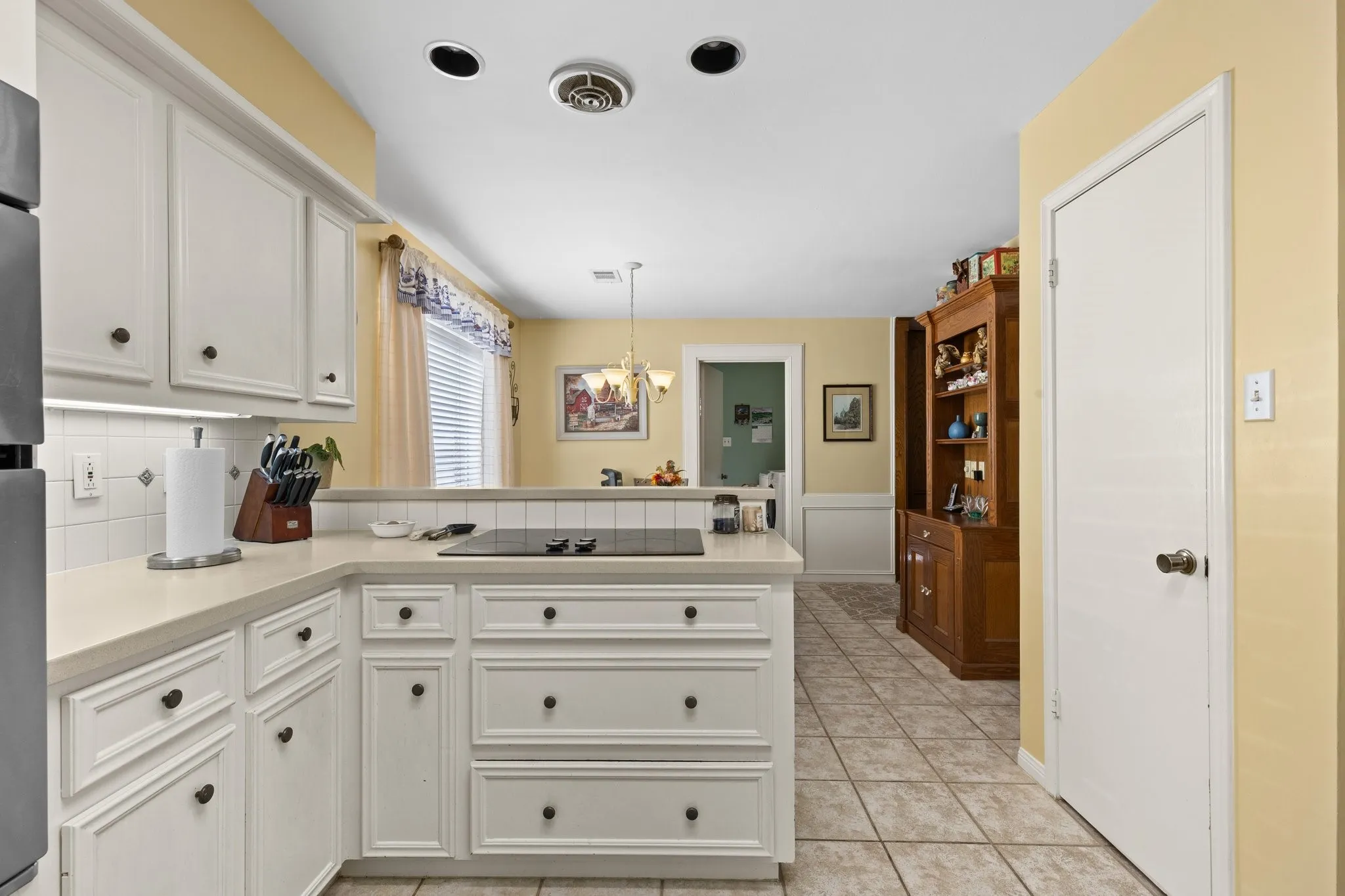 Kitchen has recessed lighting, KitchenAid appliances, pot & pans storage, electric cooktop, double oven