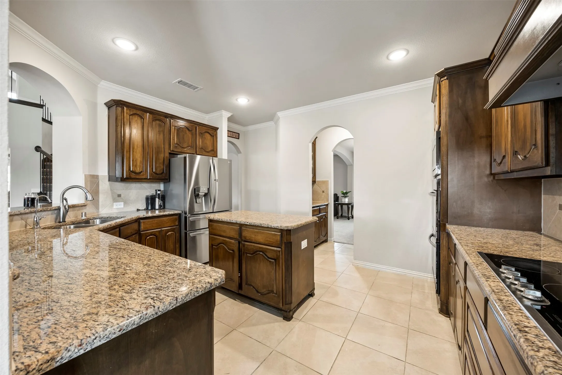 Another view of the kitchen leading to coffee bar, pantry, and dining room for convenient serviing