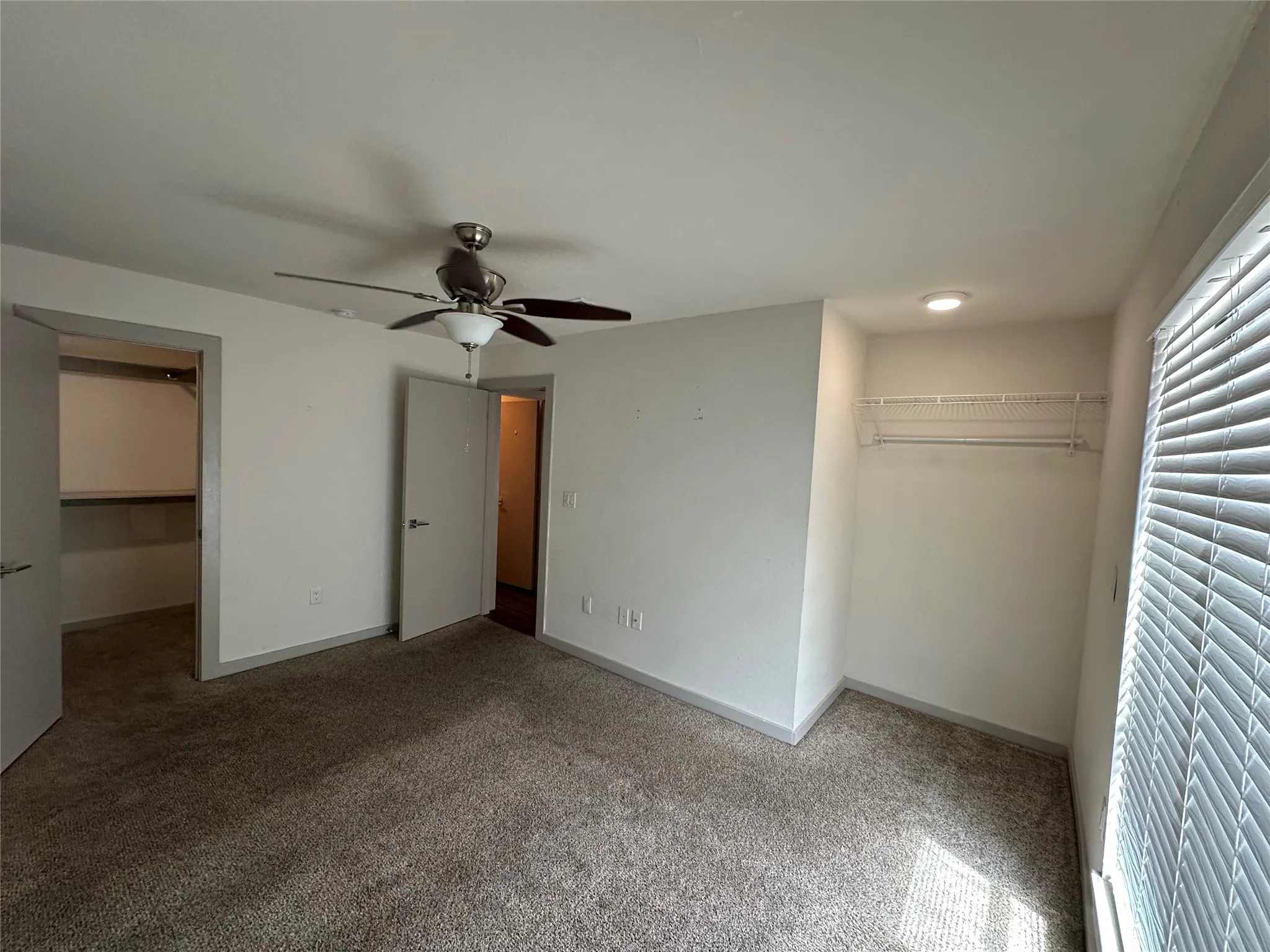 Carpeted room featuring a ceiling fan with light, recessed lighting, and a wire closet system with shelving