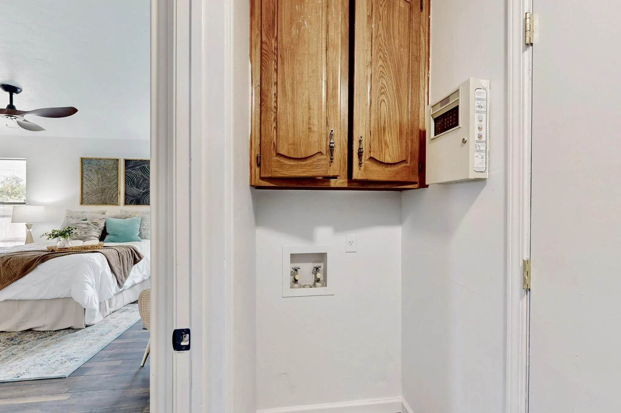 Dedicated laundry area featuring a wall-mounted wood cabinet and utility hookups