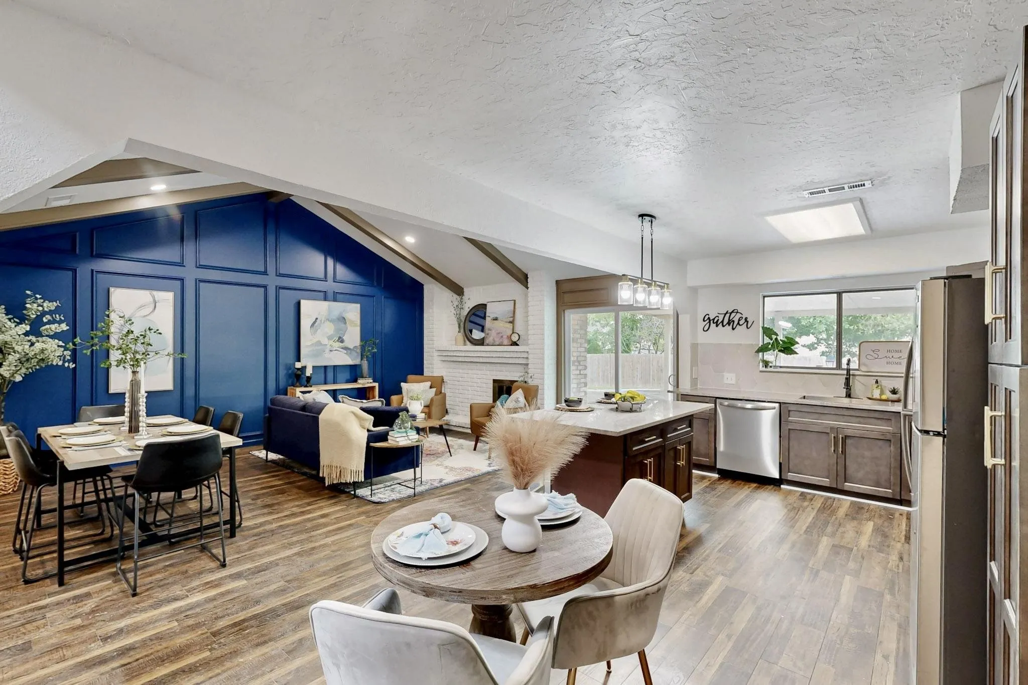 Open concept living area featuring wood-finish flooring throughout