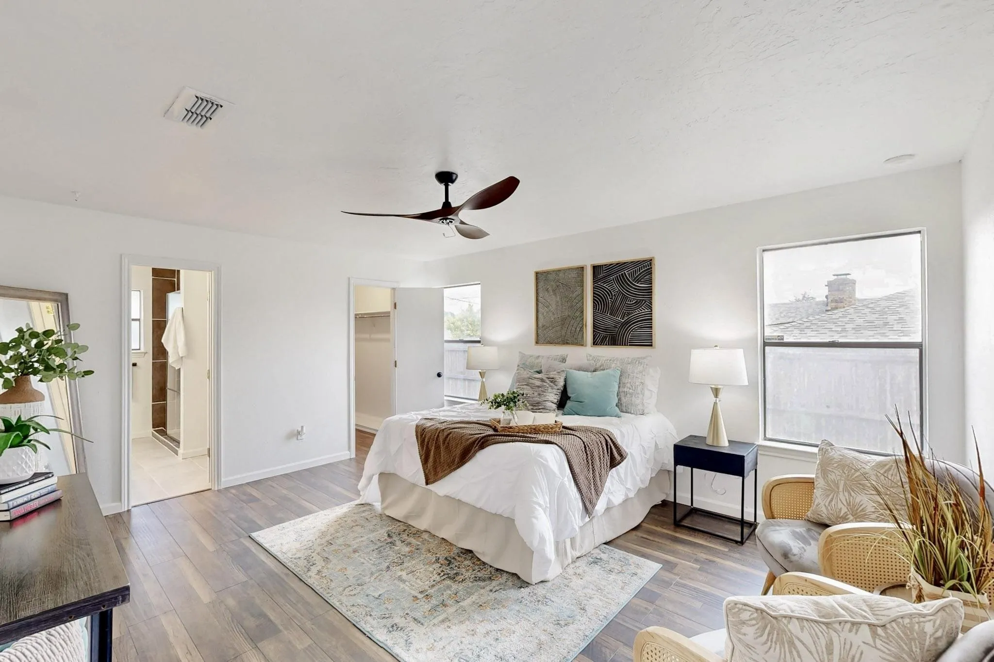 Bedroom featuring wood-finish flooring, white walls, and a contemporary ceiling fan