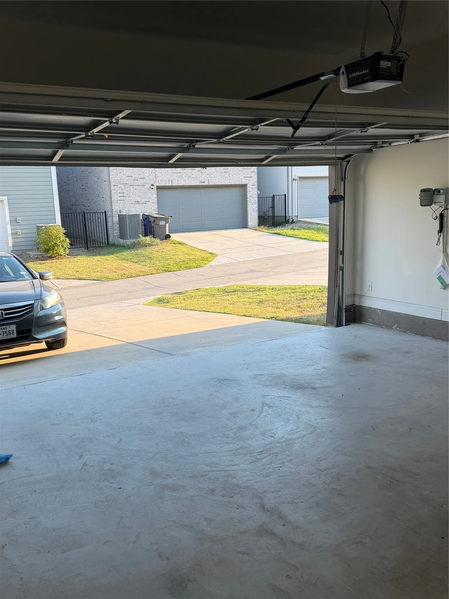 Concrete garage flooring with an overhead garage door opener