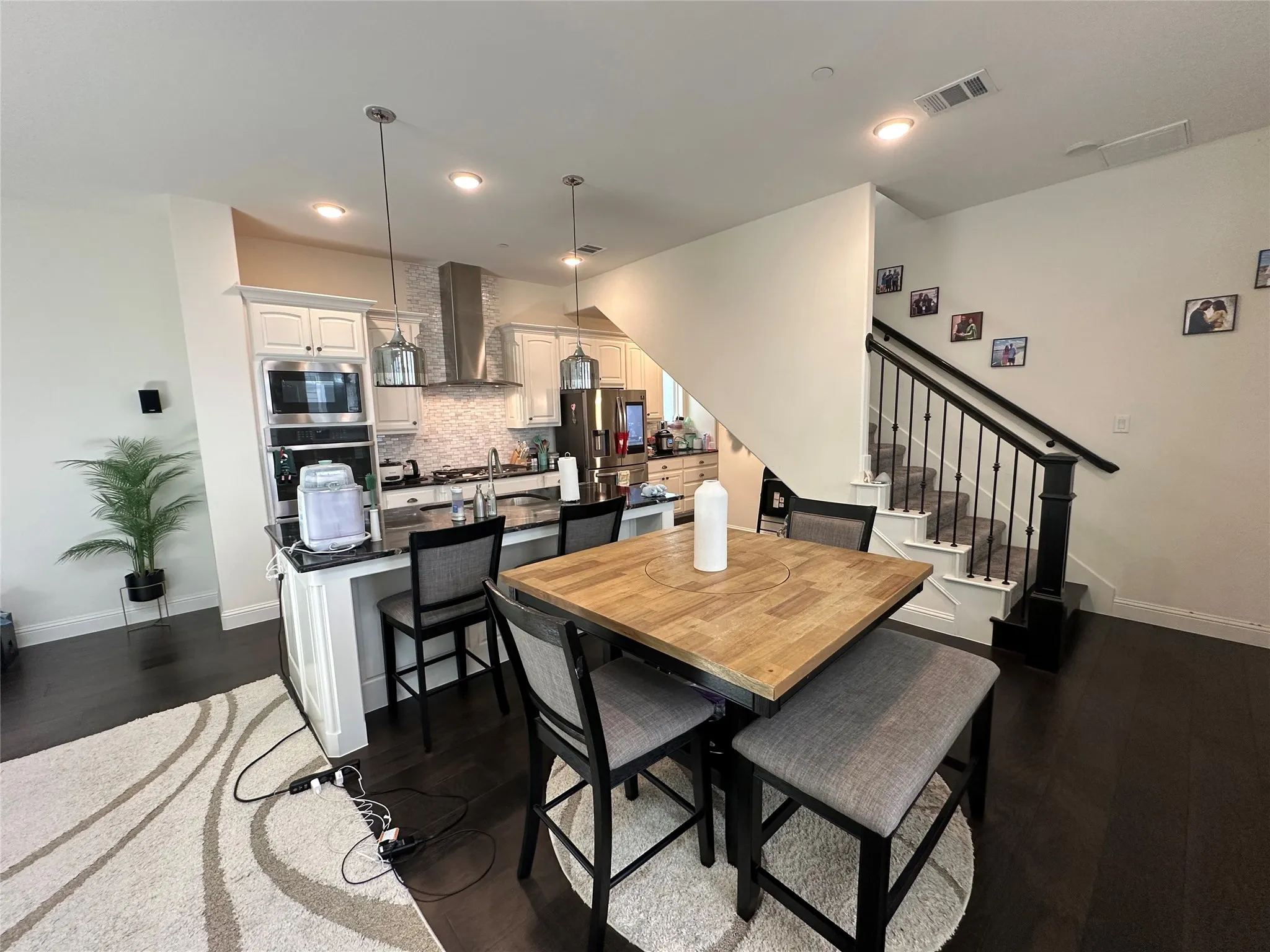 Open-concept living space featuring dark wood-finish flooring
