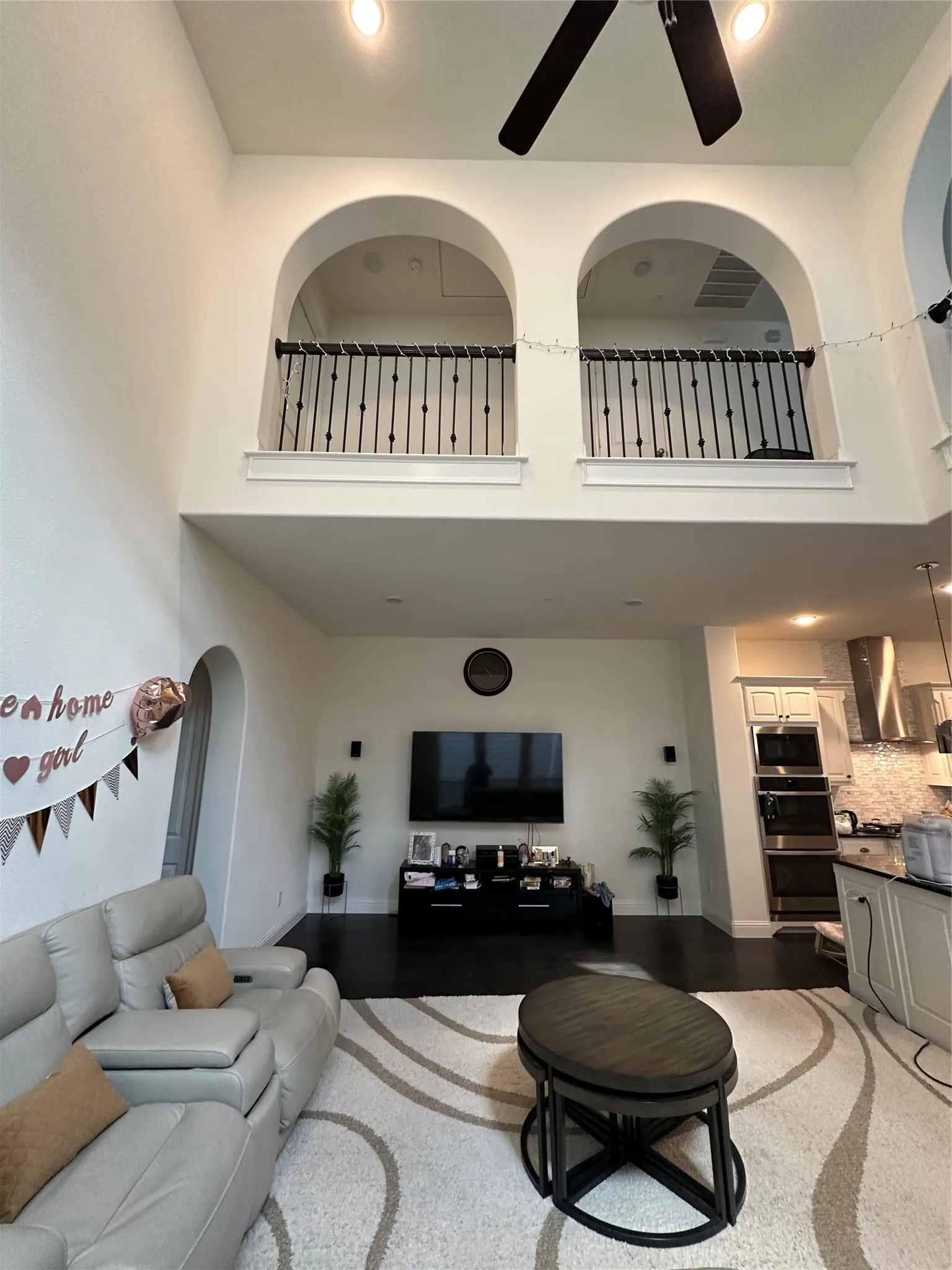 High ceilings with recessed lighting and a ceiling fan