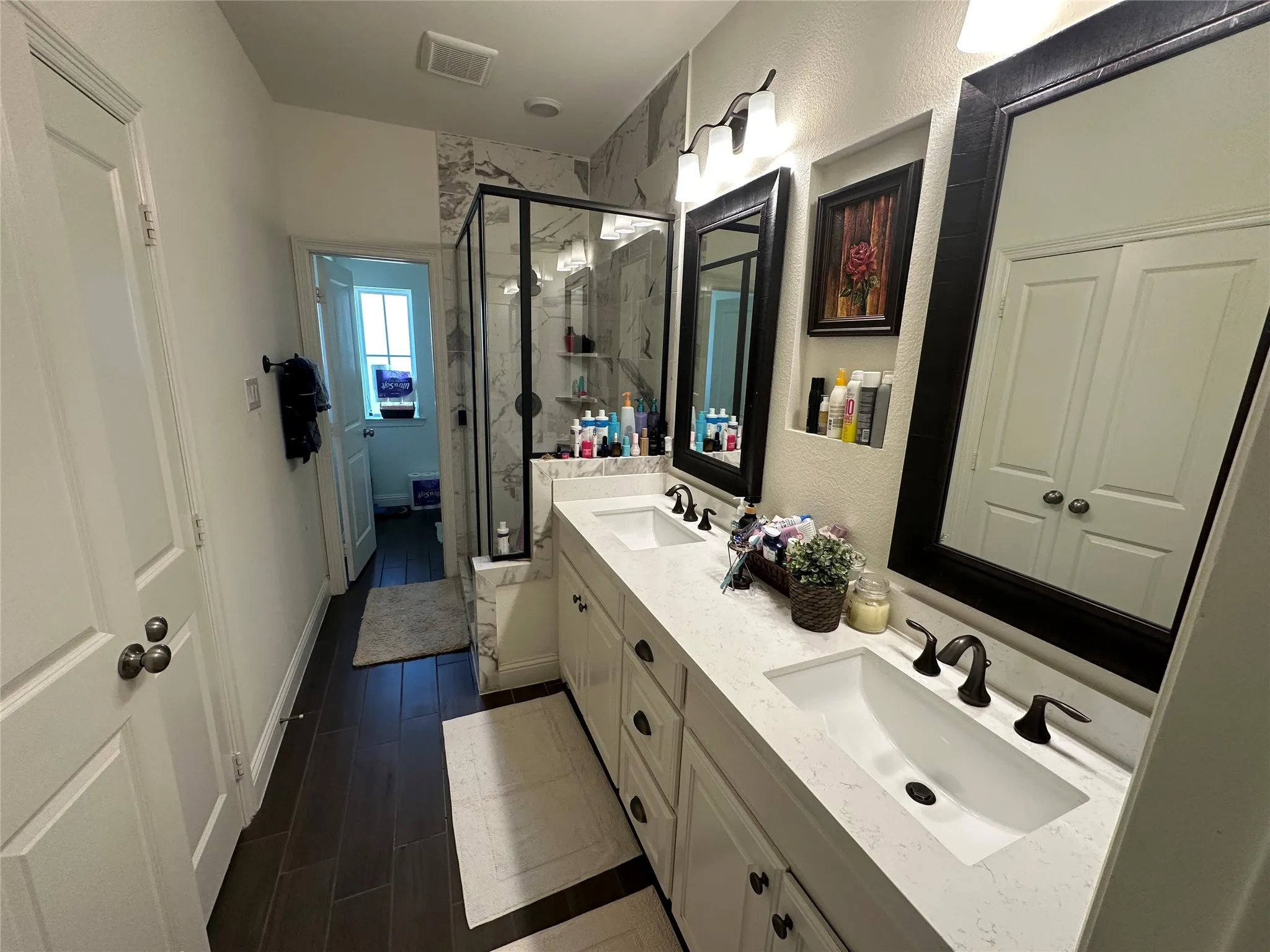 Double vanity with integrated rectangular sinks and bronze-finish fixtures