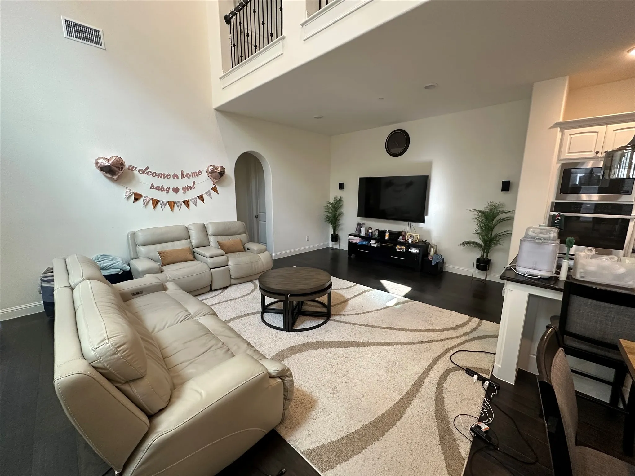 Two-story living area featuring dark wood-finish flooring.