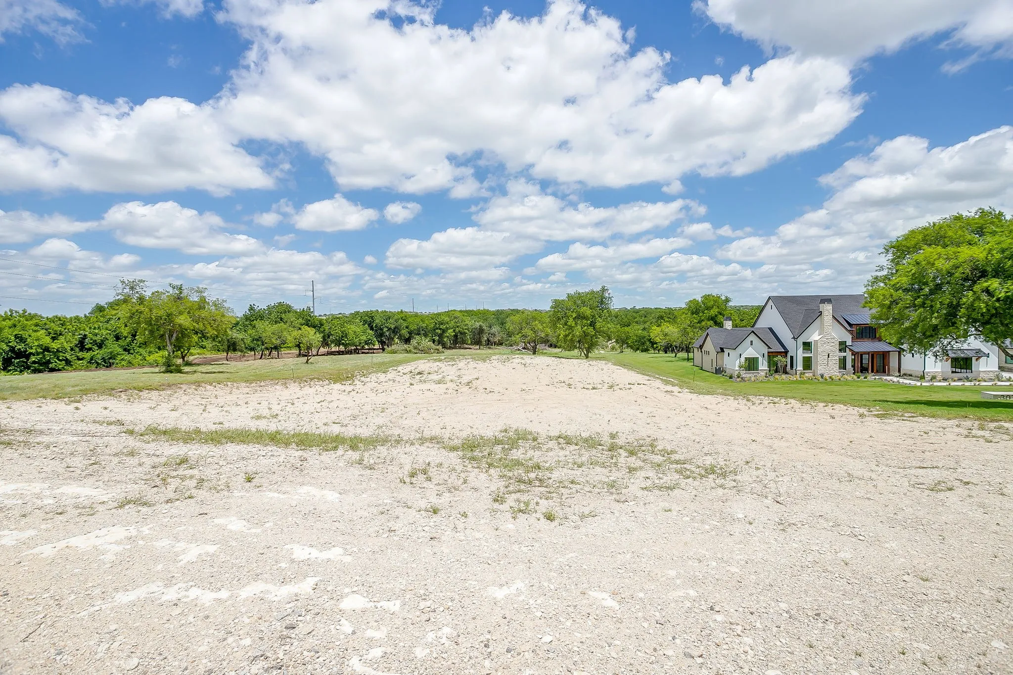 Expansive undeveloped lot with existing green space and mature trees