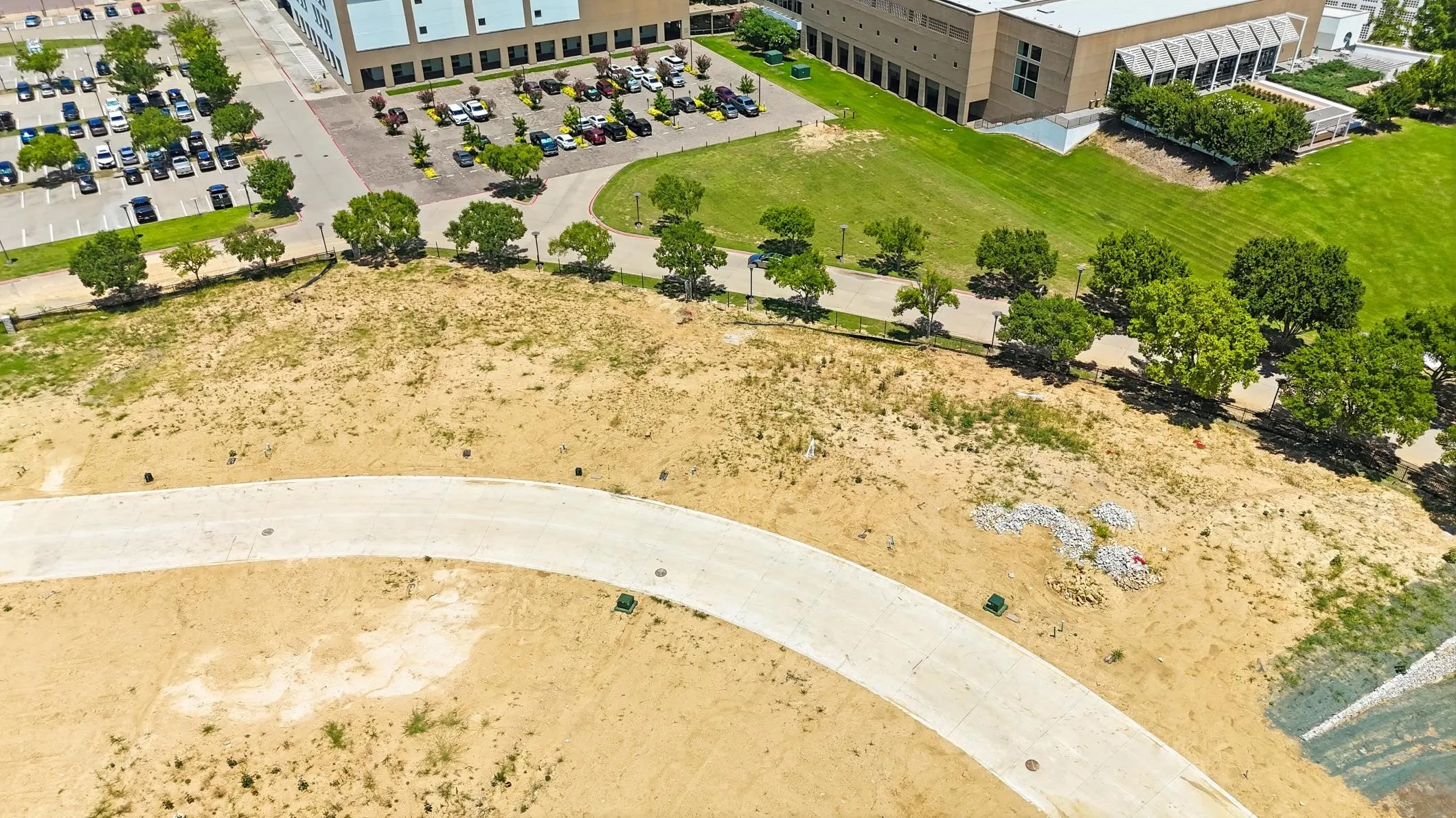 Expansive land parcel featuring a curved paved pathway