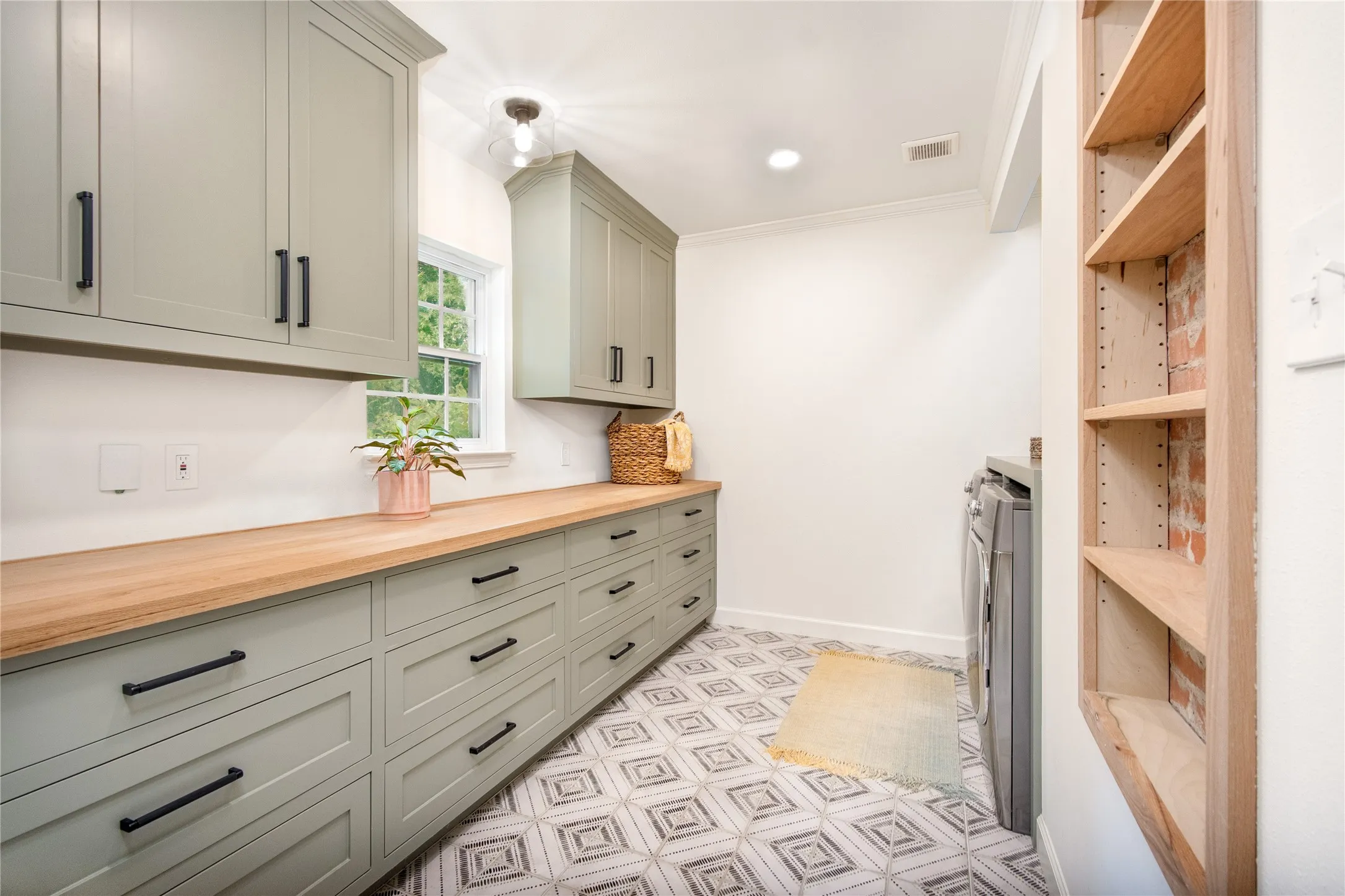 Laundry room can serve as a butler's pantry. Lots of storage!