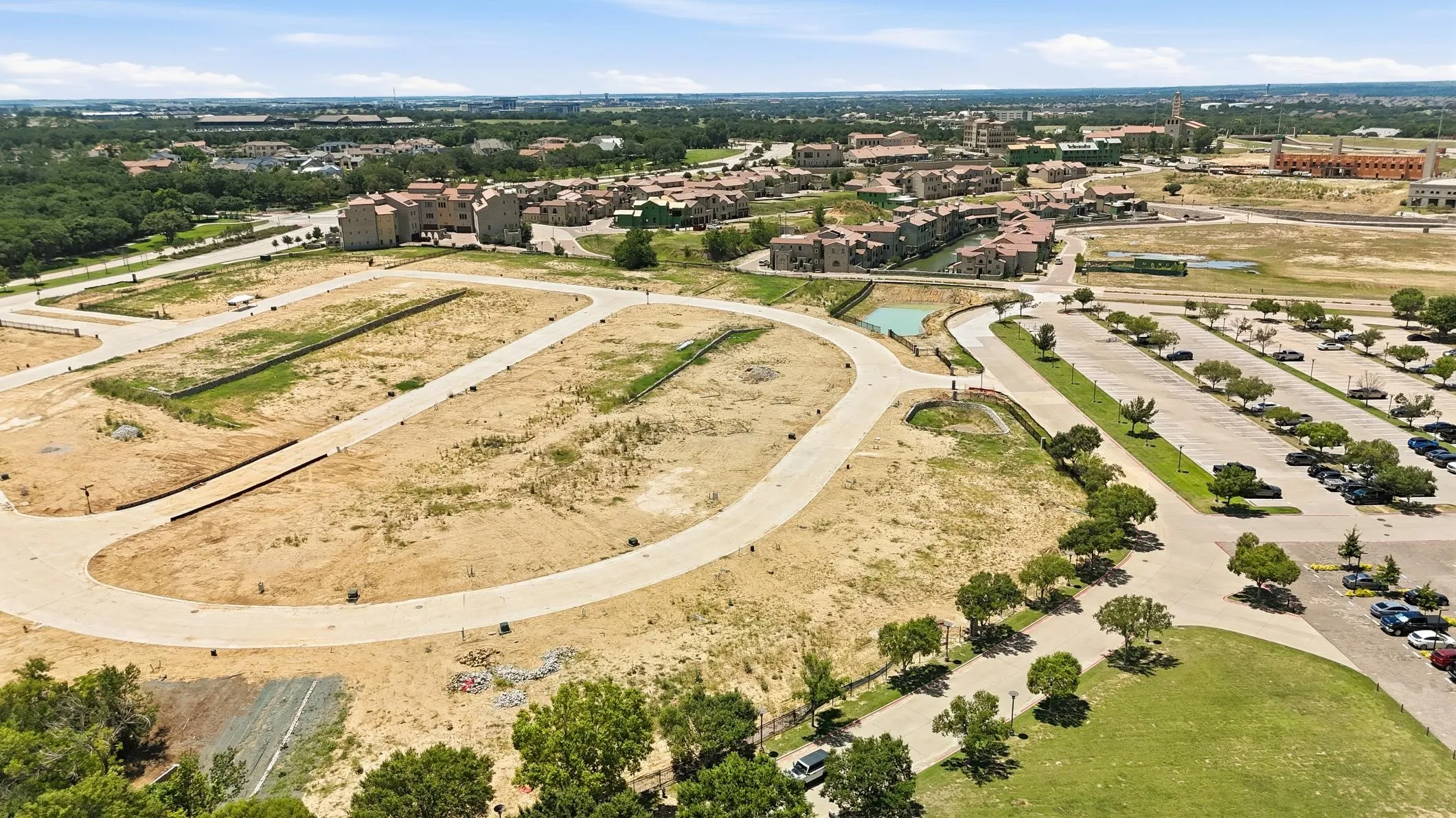 Developed land featuring paved roads and partially graded parcels