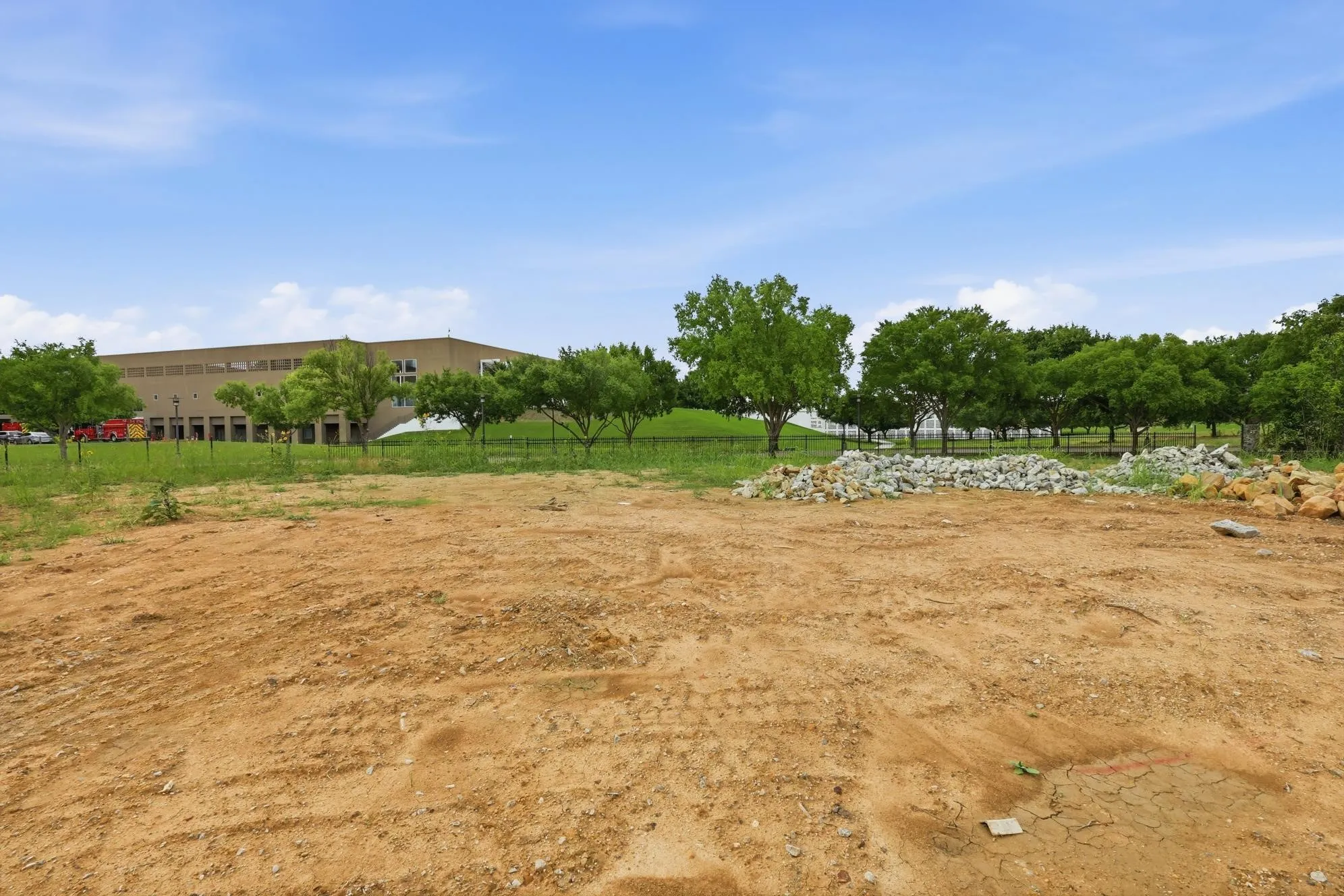 Expansive cleared land parcel with scattered rock piles