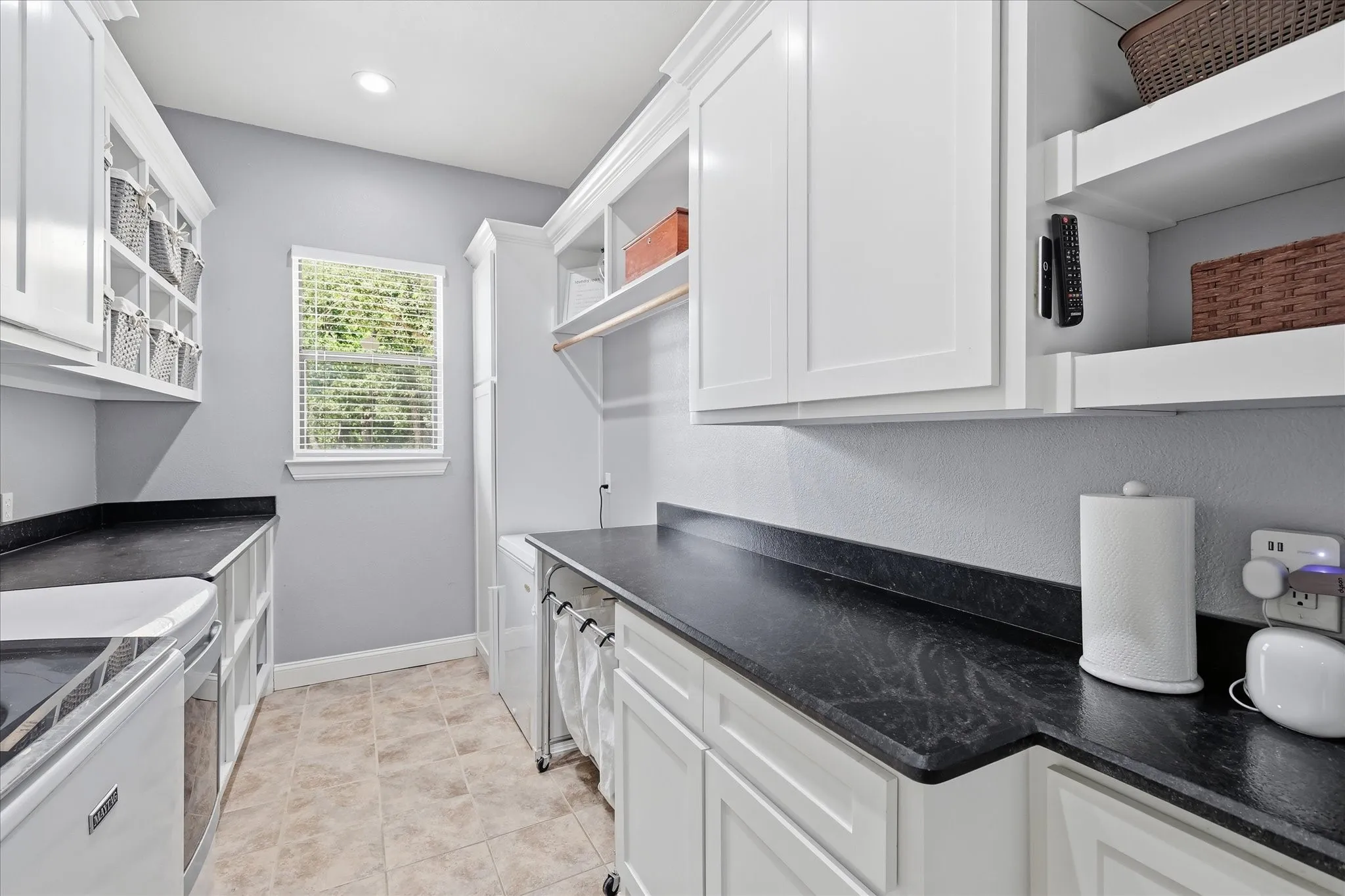 Large laundry with custom storage and room for freezer