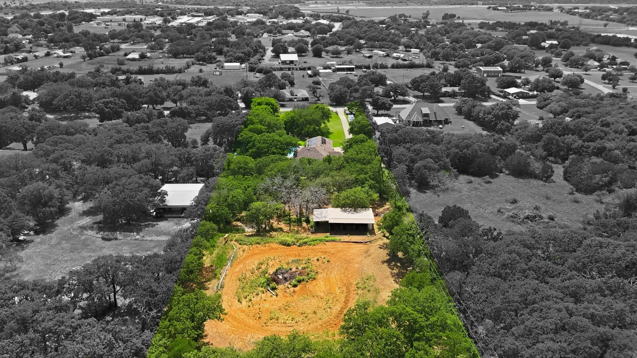 Rear view of property with barn and cleared open arena