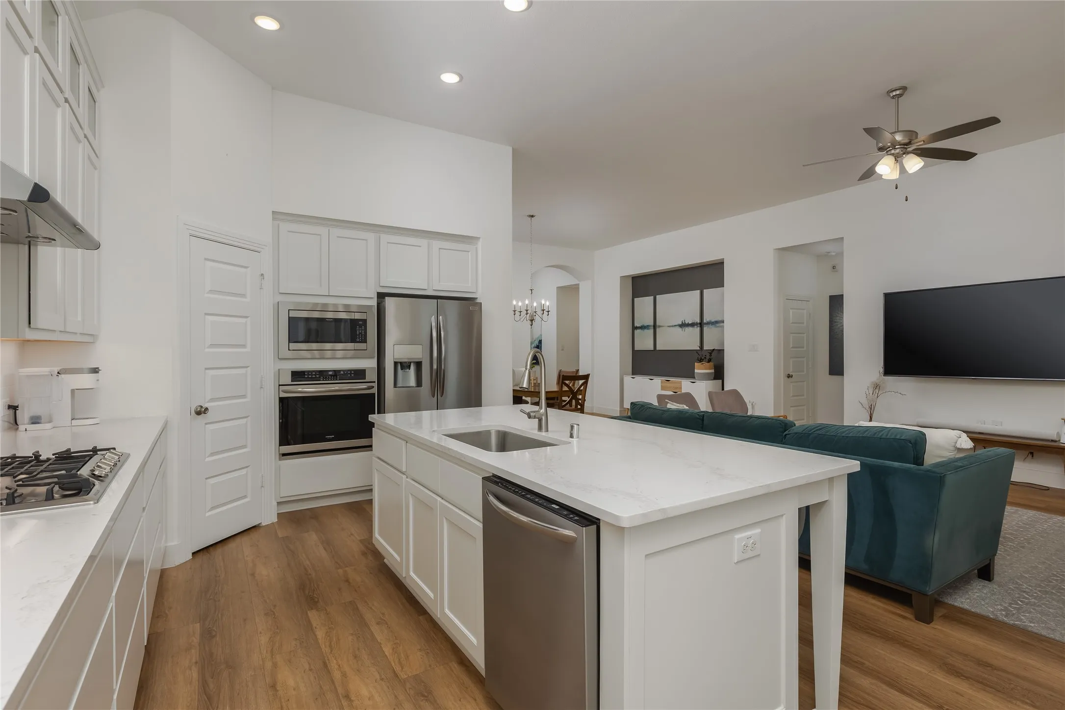 Modern kitchen featuring white cabinetry and light-toned countertops