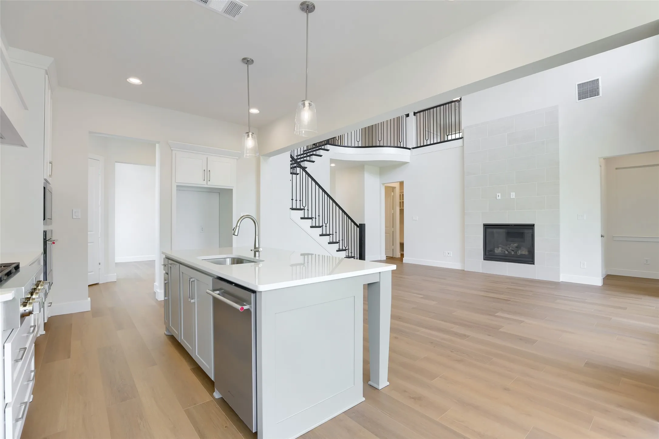 Open-concept living area featuring light wood-finish flooring throughout