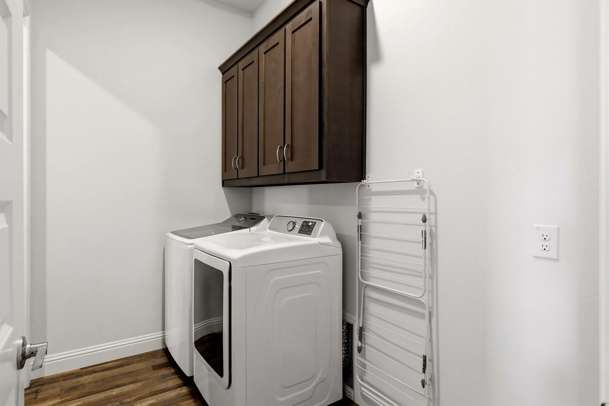 Laundry room with door to primary closet and 2nd door to hallway.