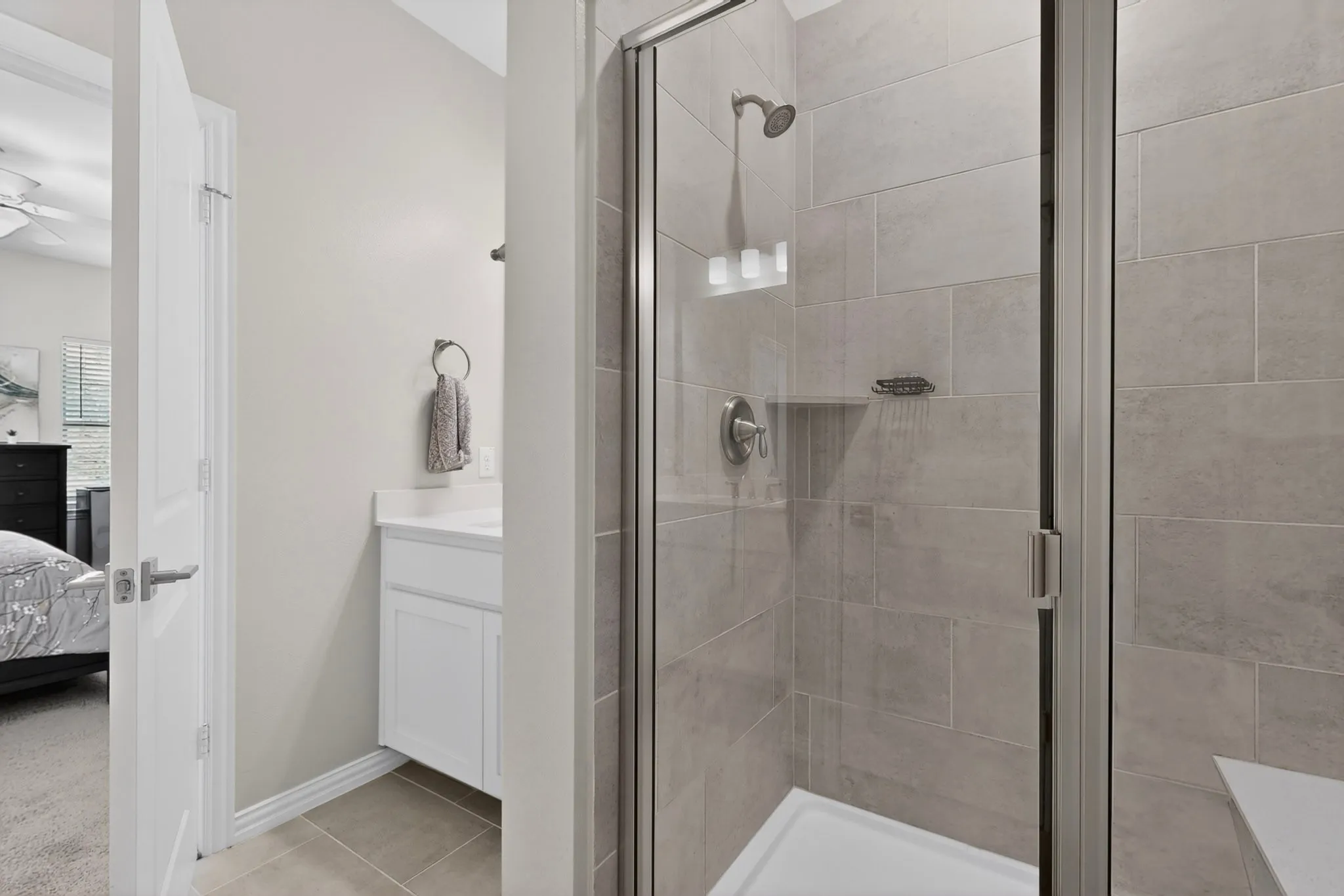 A modern primary bathroom featuring a spacious enclosed shower area.
