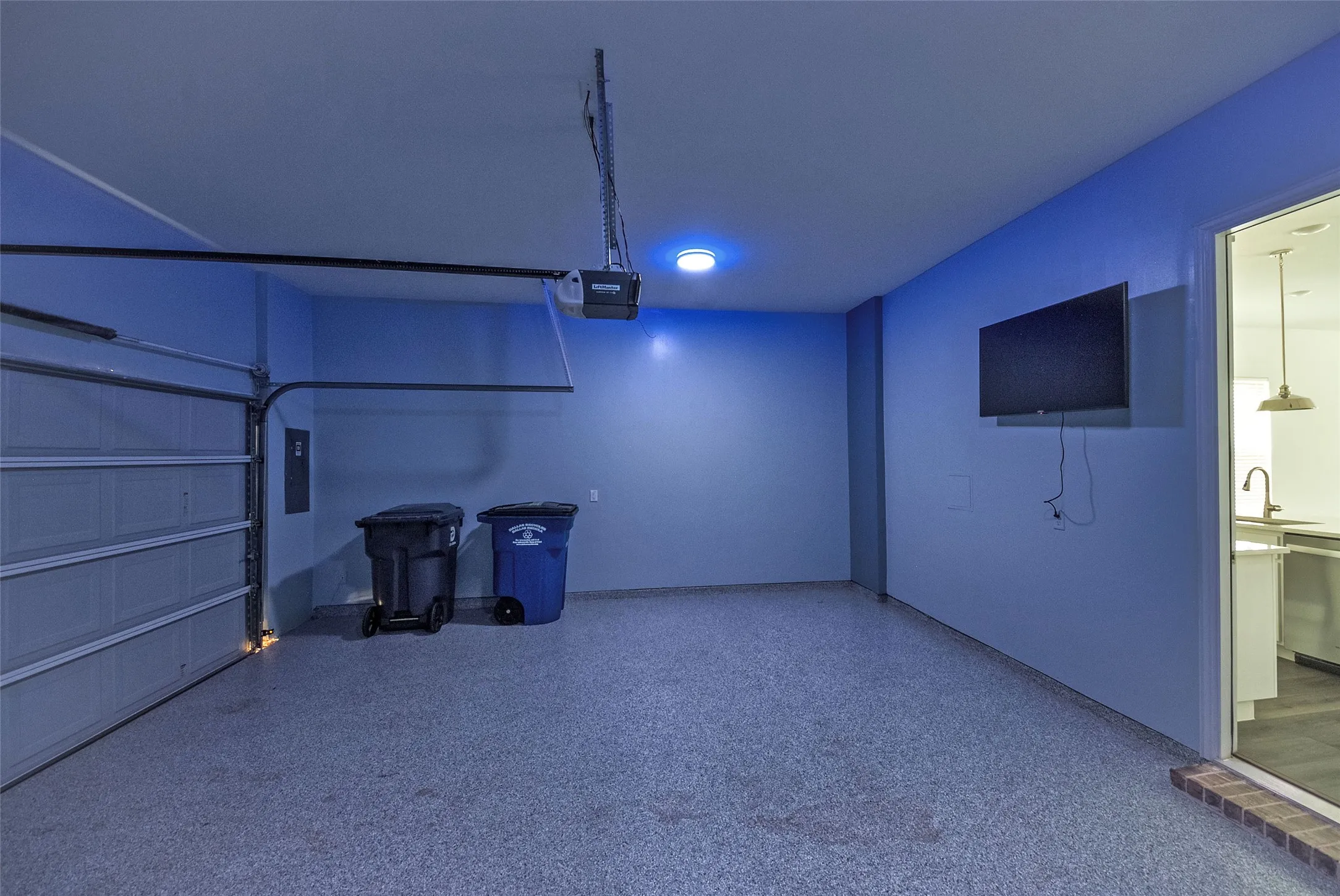 Inside the spacious garage with a mounted television
