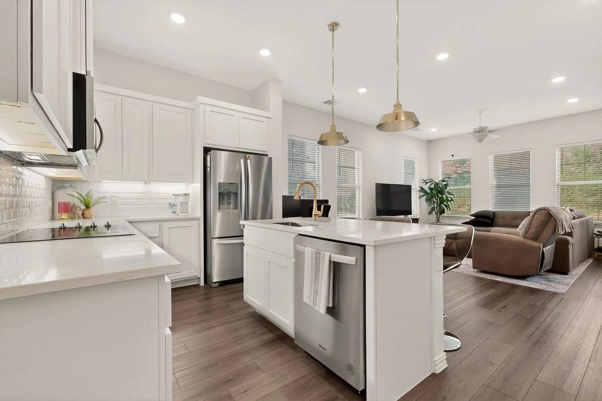 Modern kitchen with white cabinets, stainless steel appliances, and a kitchen island with sink