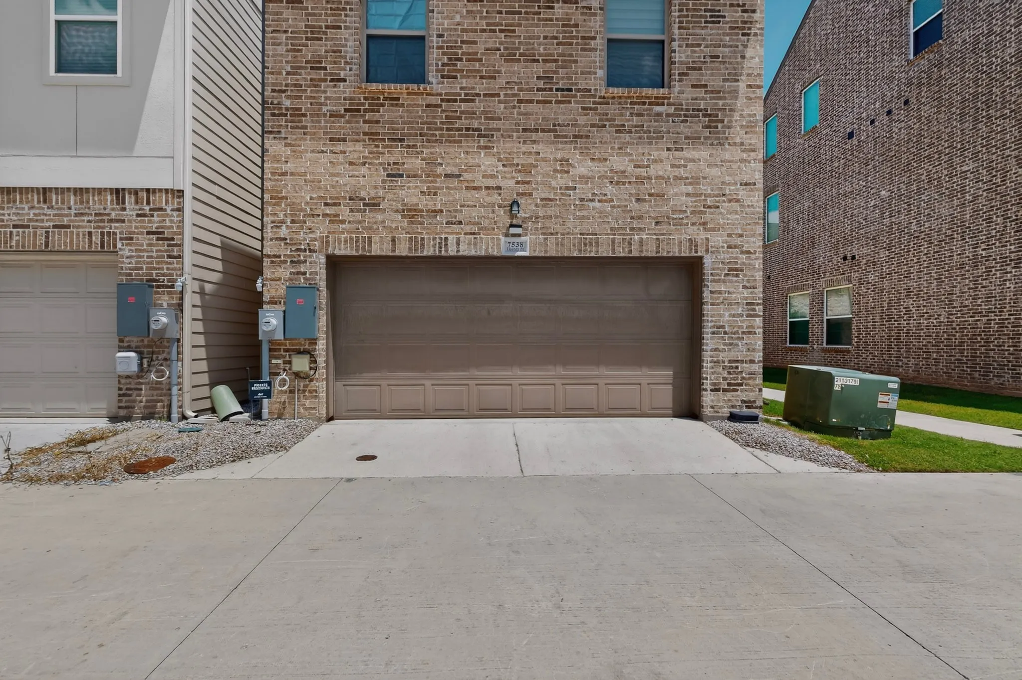 A garage with a neatly paved driveway for easy​​‌​​​​‌​​‌‌​‌‌​​​‌‌​‌​‌​‌​​​‌​​ access.