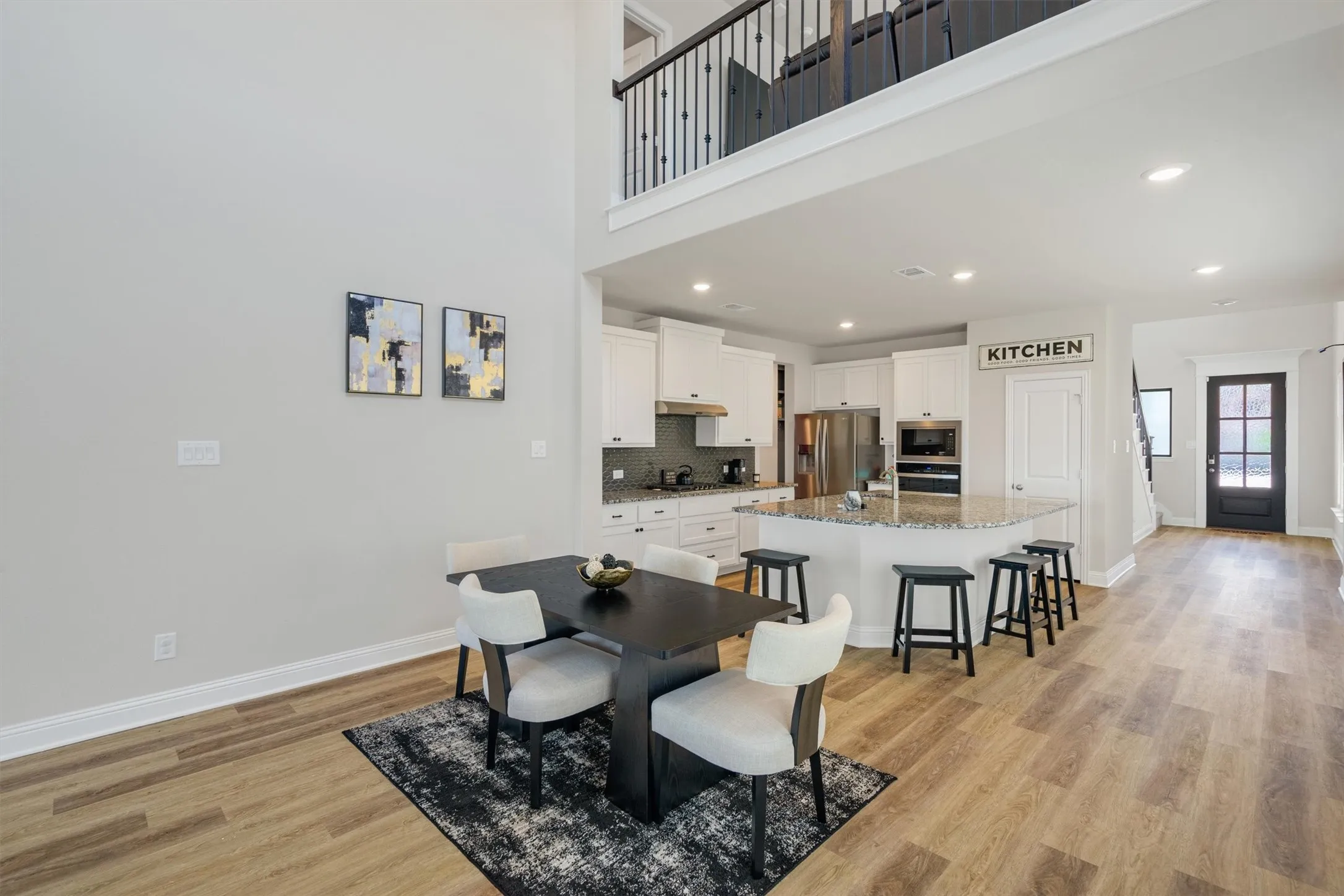 Open-concept living space featuring high ceilings and wood-finish flooring