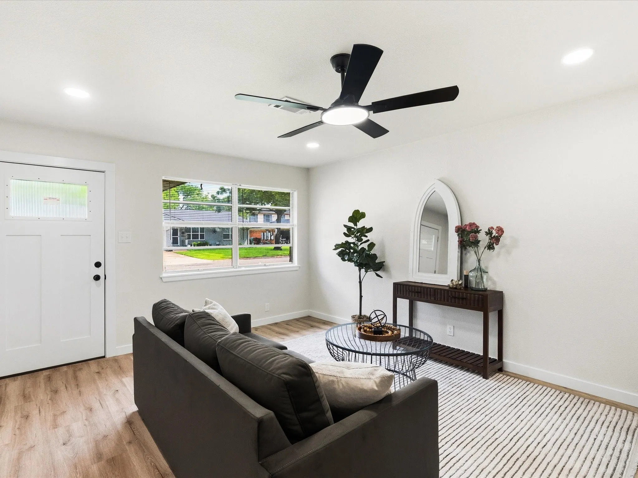 Living room features updated paint, ceiling fans, updated lighting, new floors and more! It is spacious for lots of furniture and very inviting.