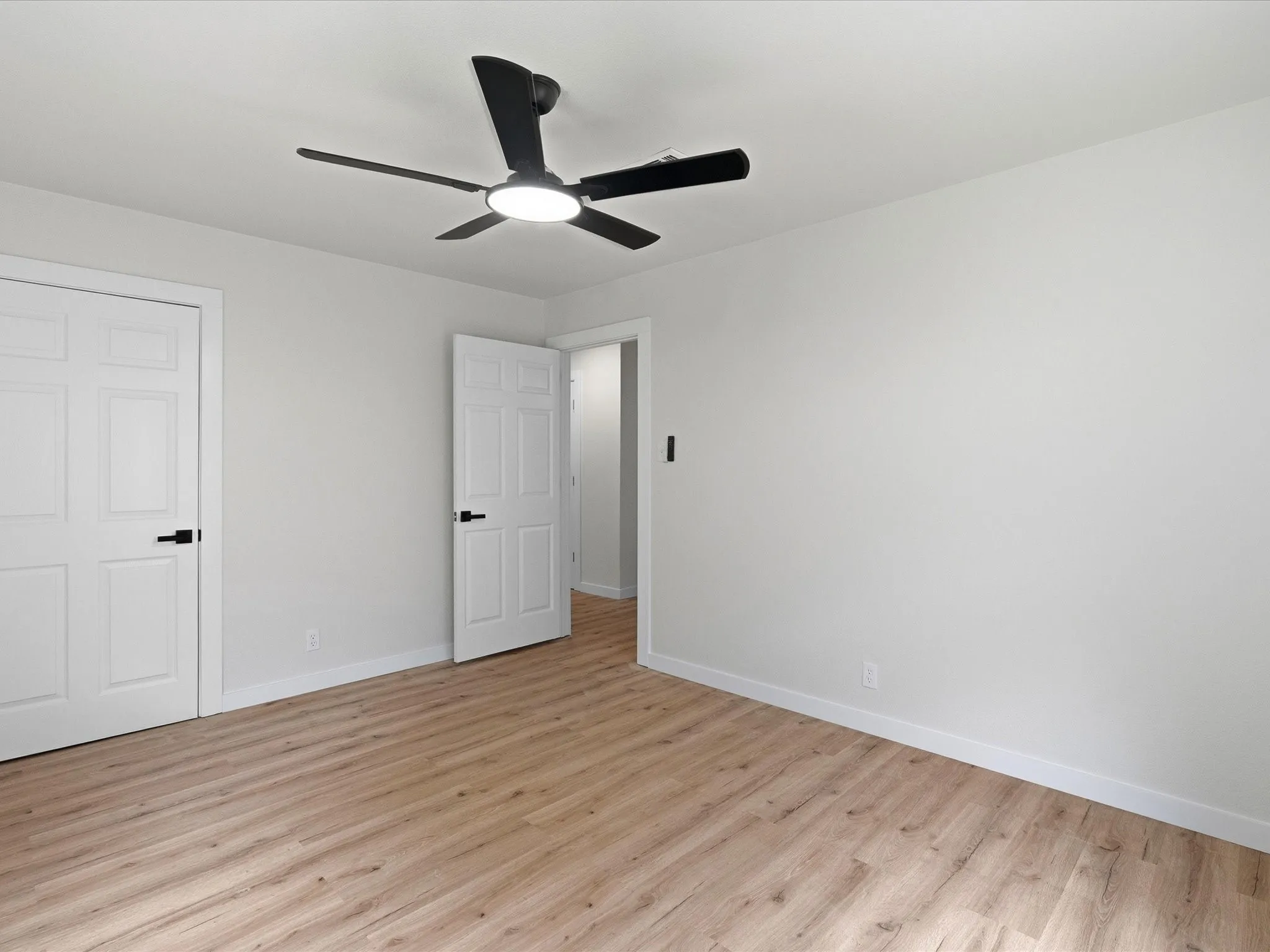 Second and third bedrooms features new paint, new floors, and ceiling fans.