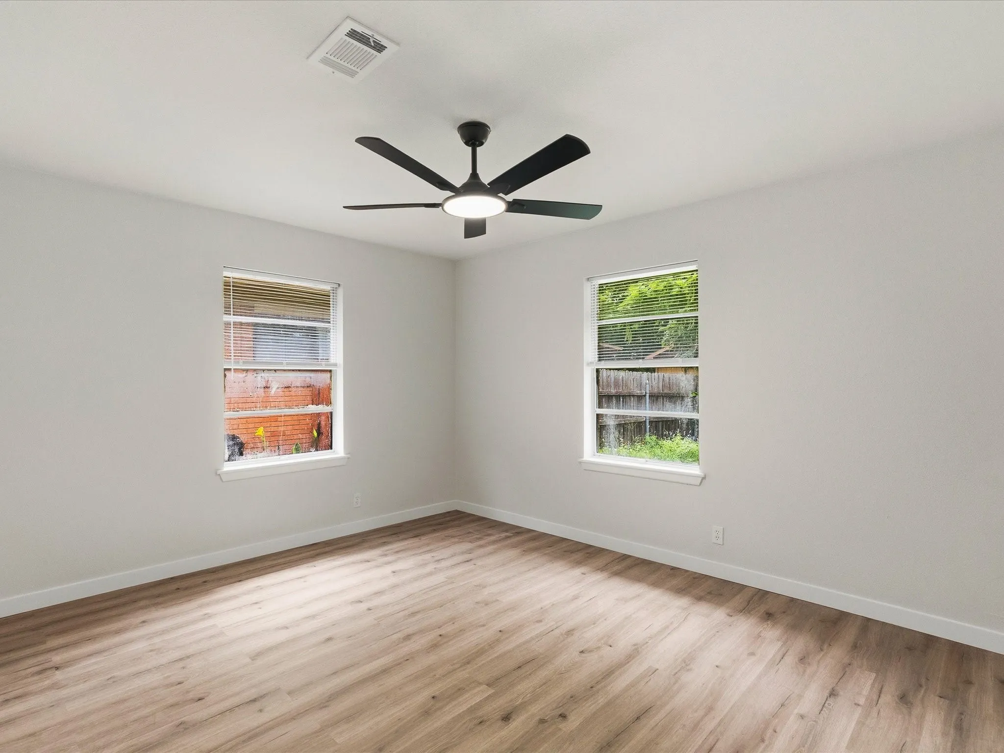 Second and third bedrooms features new paint, new floors, and ceiling fans.
