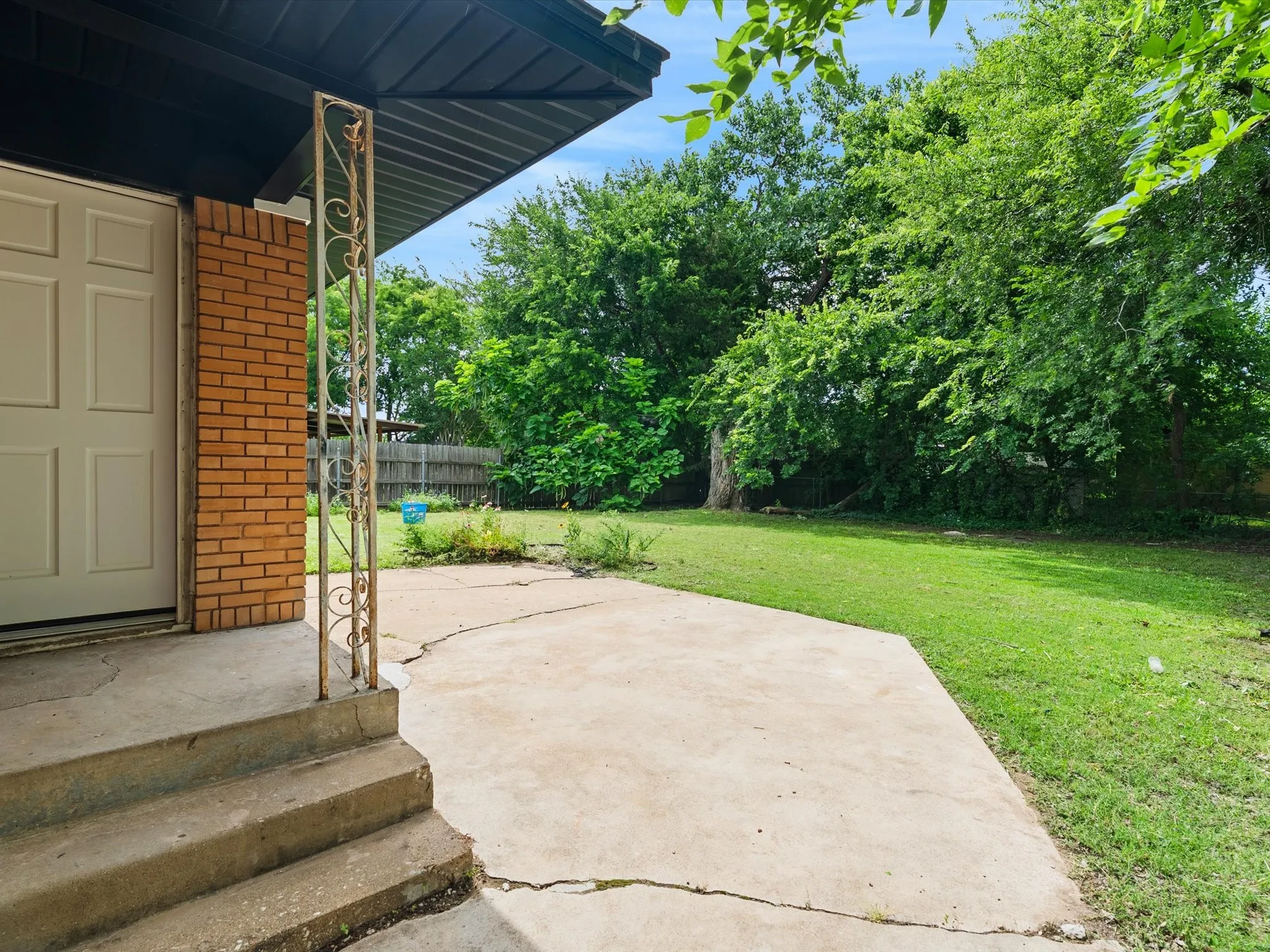 The backyard is huge with lots of space for entertaining or relaxing. There is a small covered porch area right off the back of the house off the kitchen and dining area.