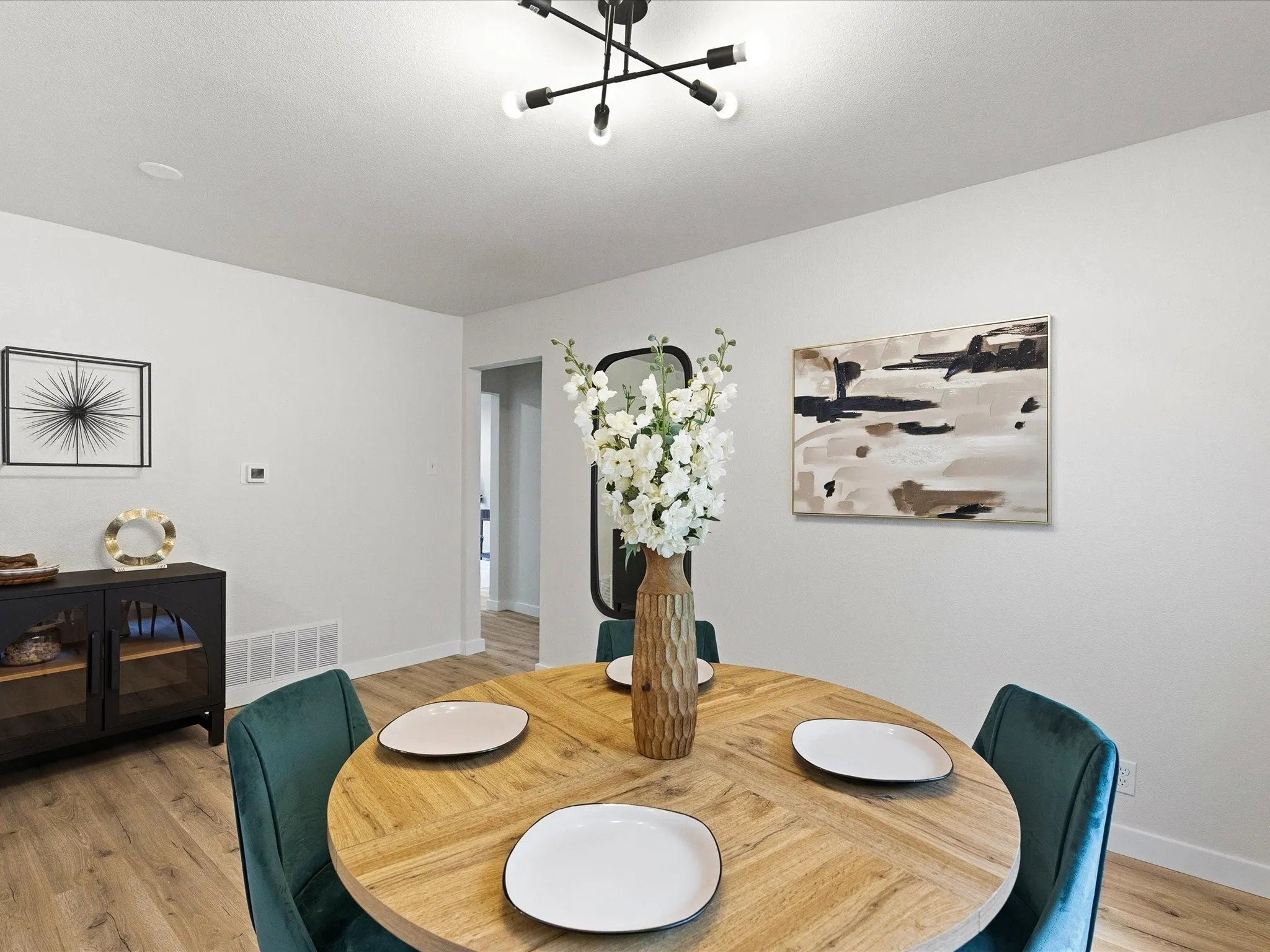 The dining area is spacious and welcoming with room for a buffet or storage. The kitchen features updated cabinets, granite counters, ss appliances, new fixtures, new paint, updated lighting and more!