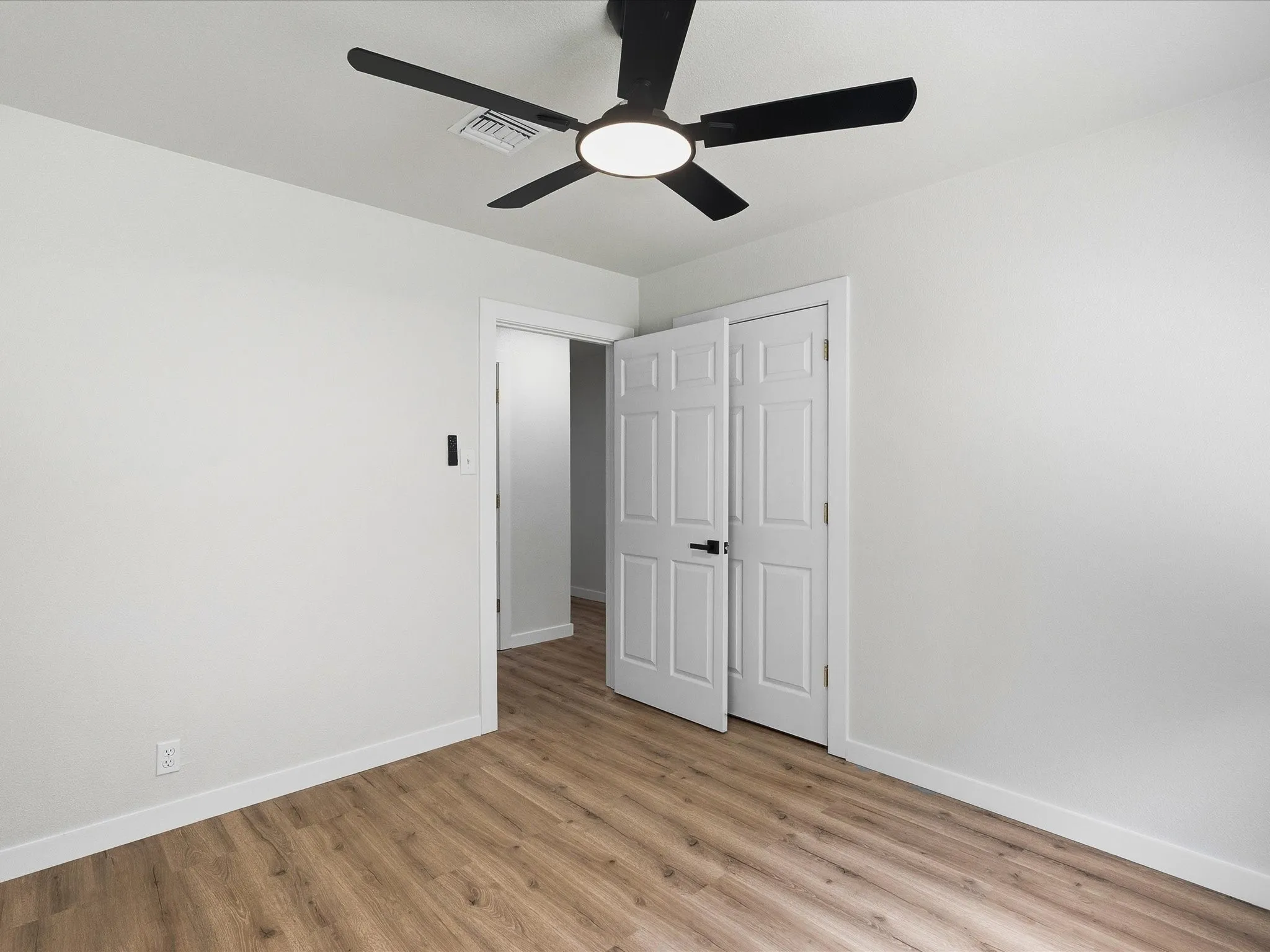 Second and third bedrooms features new paint, new floors, and ceiling fans.