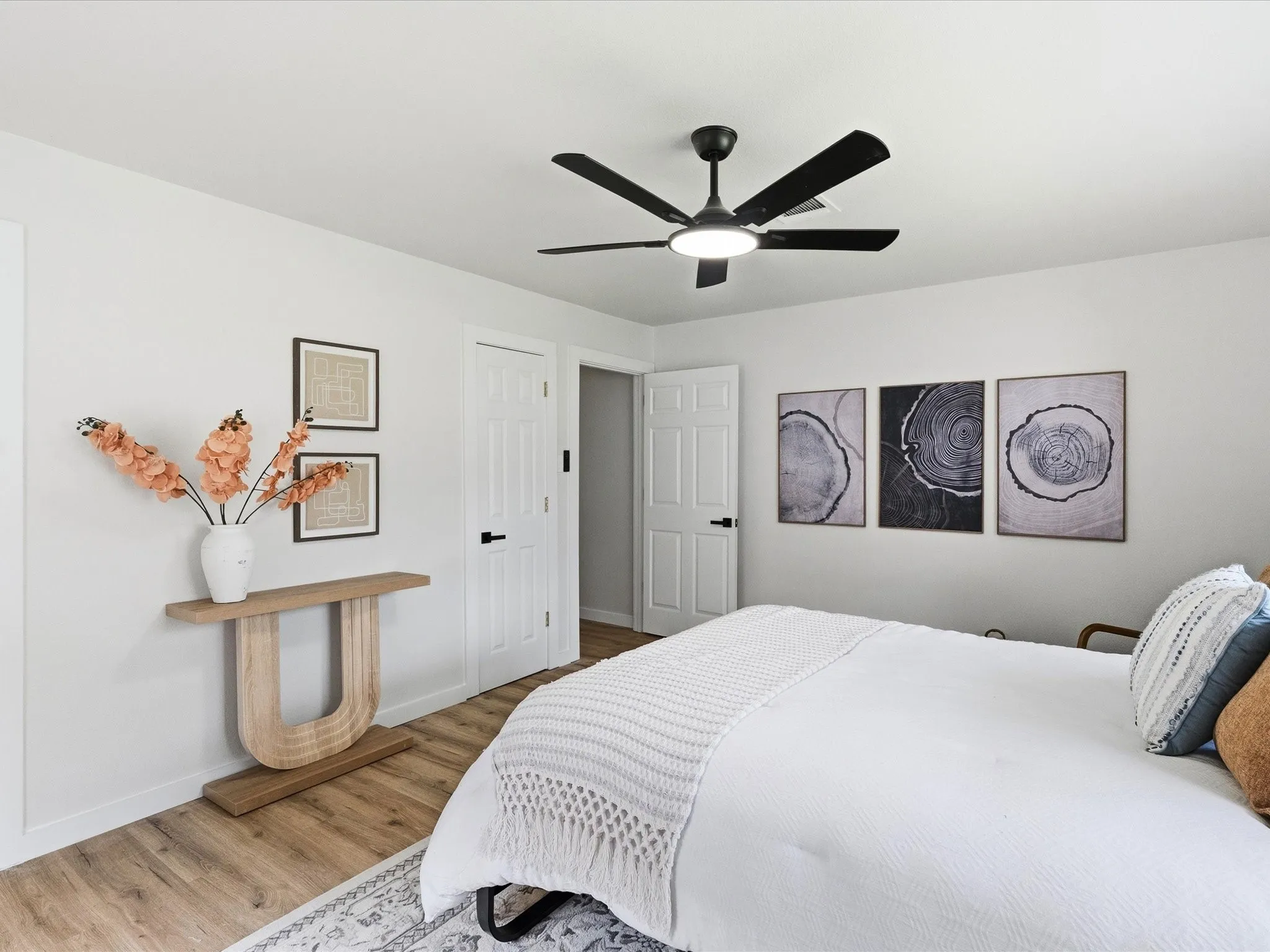 Primary bedroom features fresh paint, new floors, ceiling fan, multiple windows for natural light, an ensuite bathroom and more!