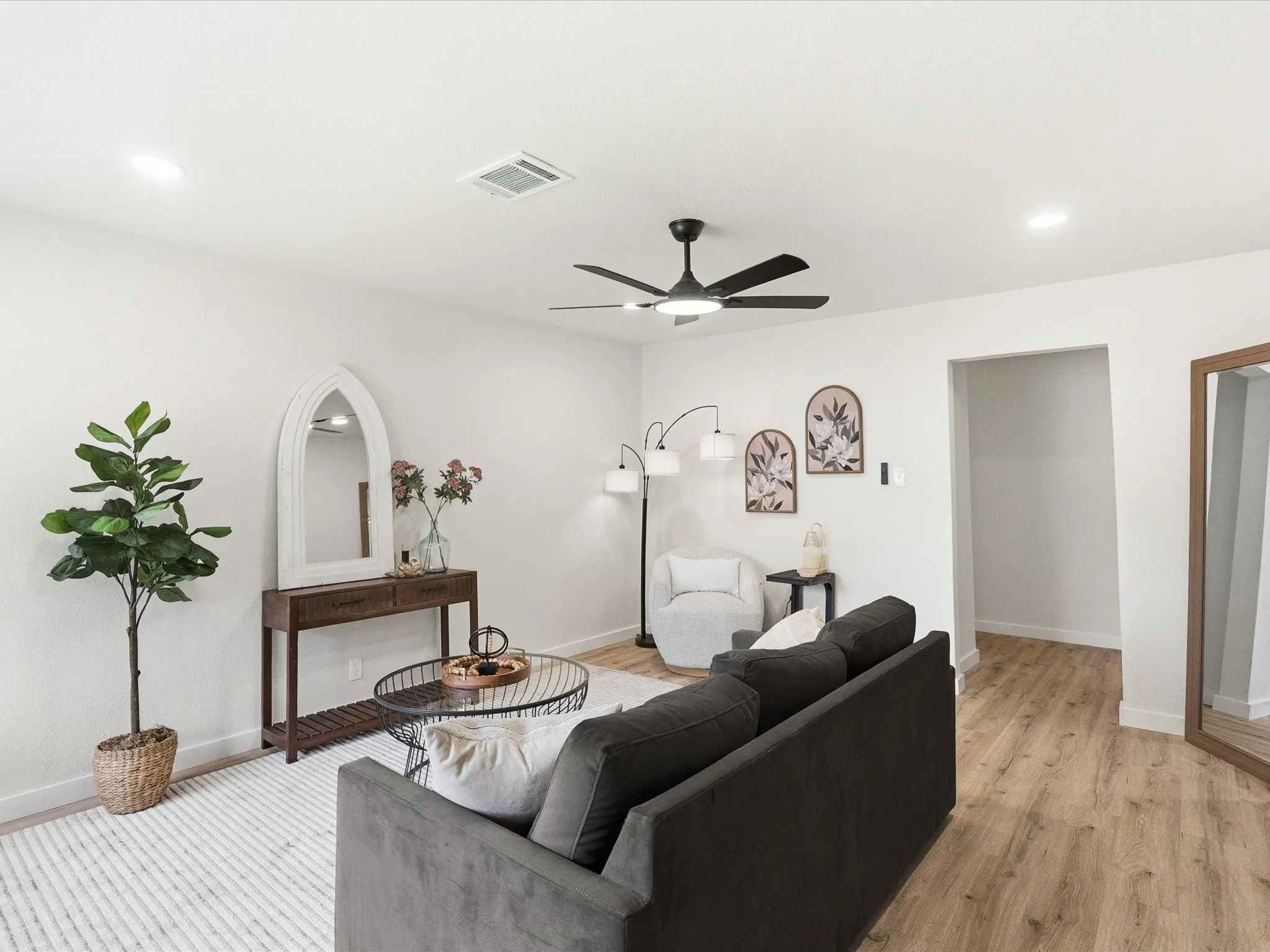 Living room features updated paint, ceiling fans, updated lighting, new floors and more! It is spacious for lots of furniture and very inviting.