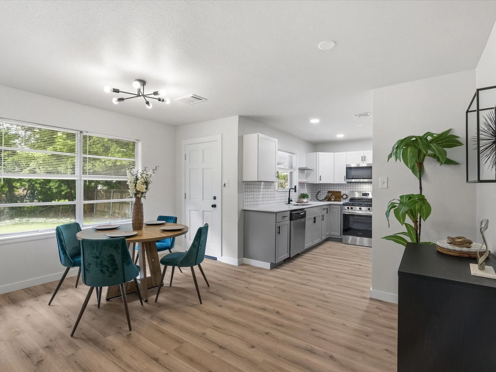 The dining area is spacious and welcoming with room for a buffet or storage. The kitchen features updated cabinets, granite counters, ss appliances, new fixtures, new paint, updated lighting and more!