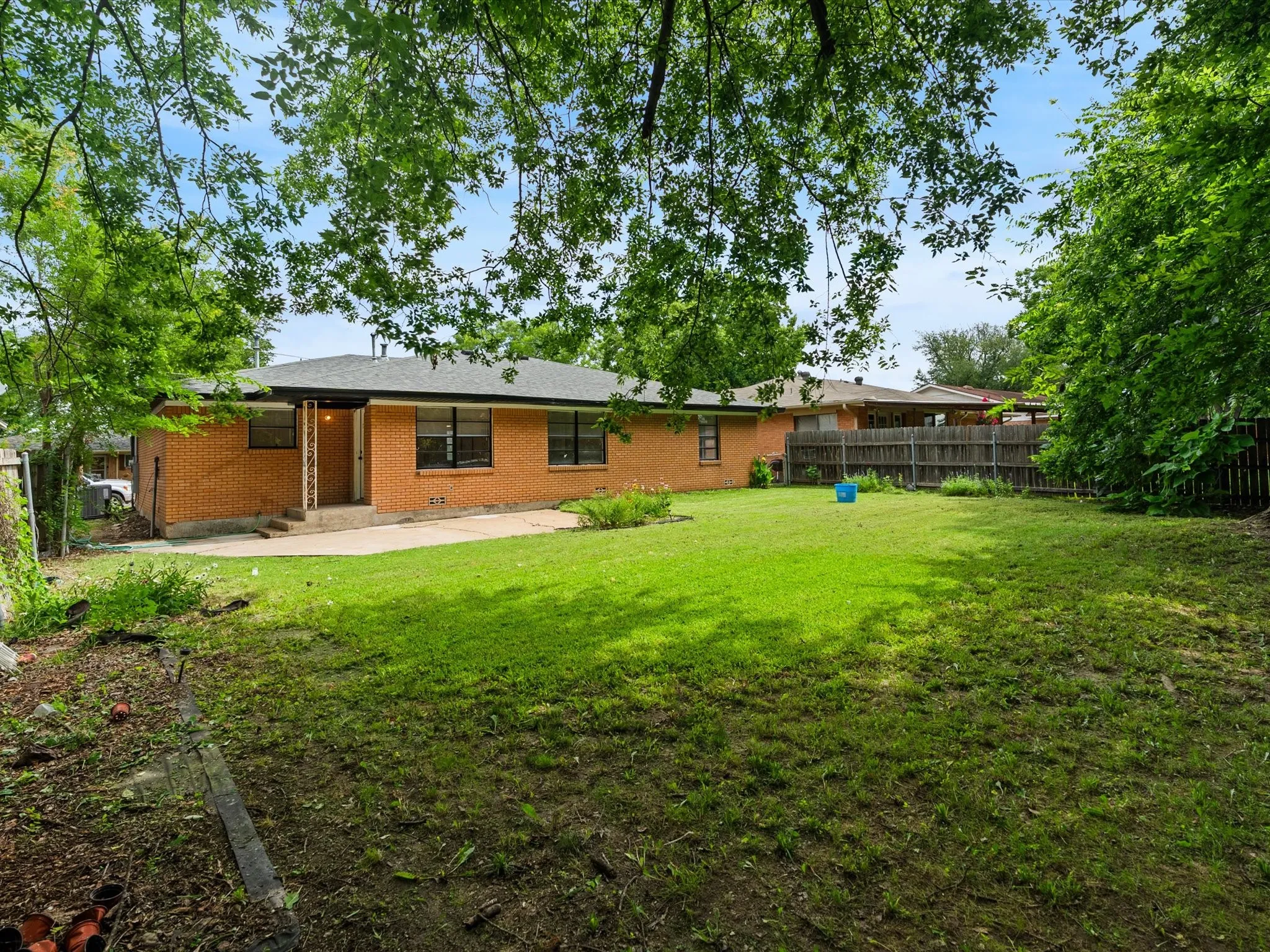 The backyard is huge with lots of space for entertaining or relaxing. There is a small covered porch area right off the back of the house off the kitchen and dining area.